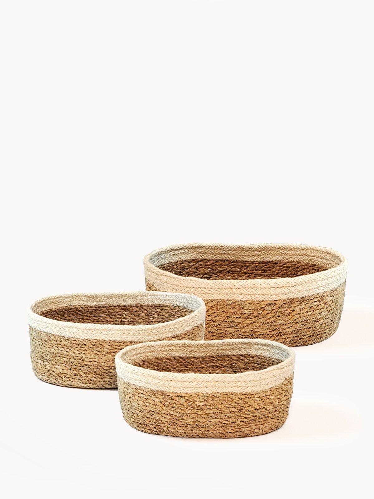 Set of three Savar Oval Bowls made from seagrass and jute, showcasing their natural and rustic design.