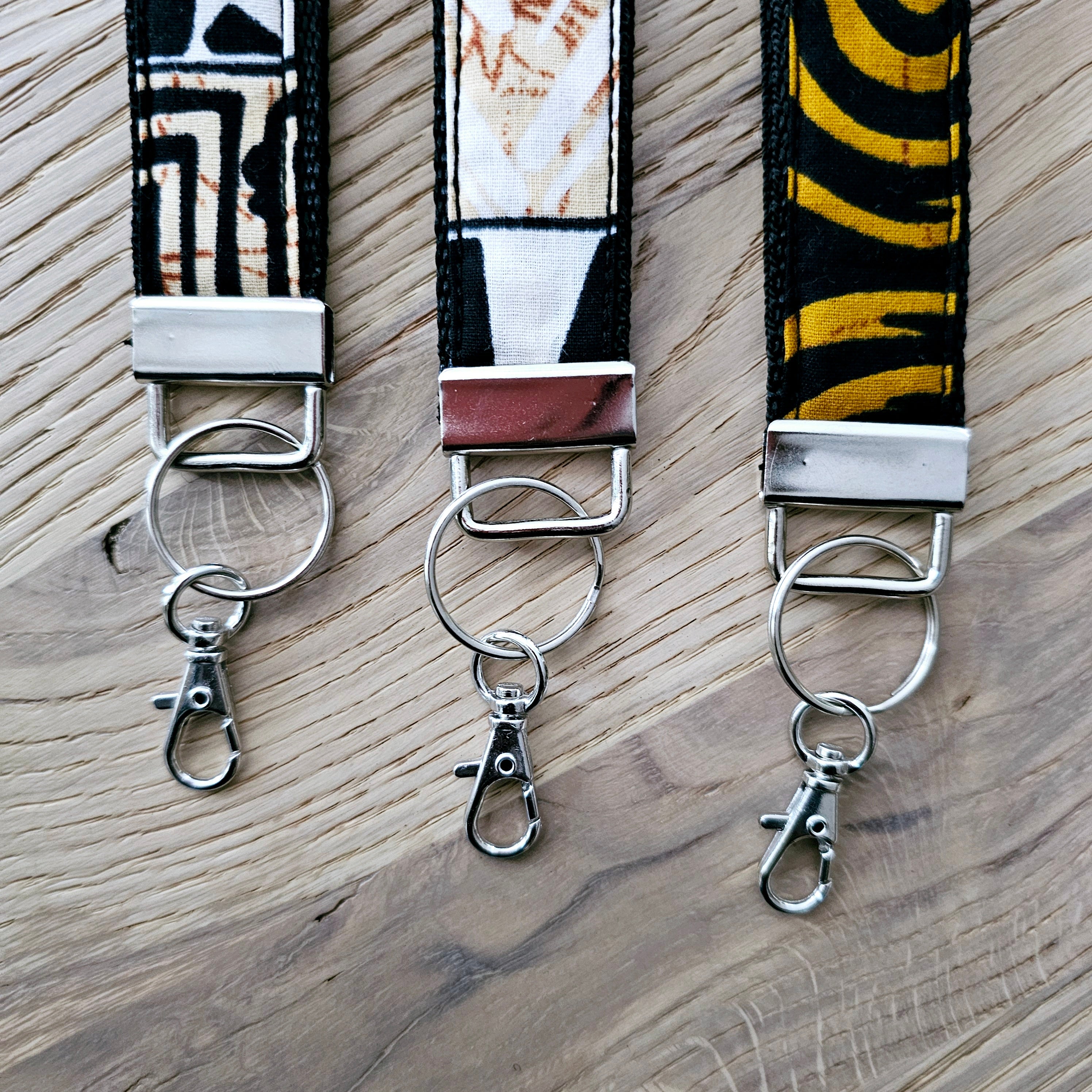 Set of 3 vibrant African print key fobs, featuring a stylish wristlet design and vegan leather lining for durability.