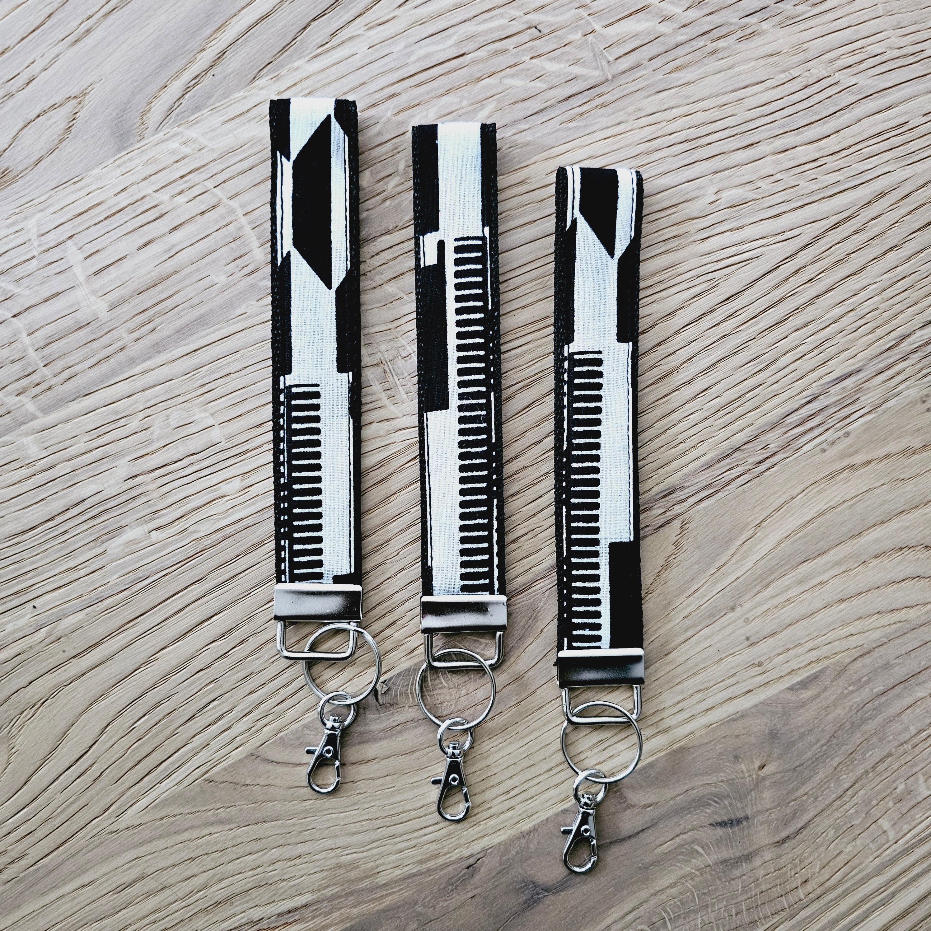 Set of 3 vibrant African print key fobs, featuring a stylish wristlet design and vegan leather lining for durability.