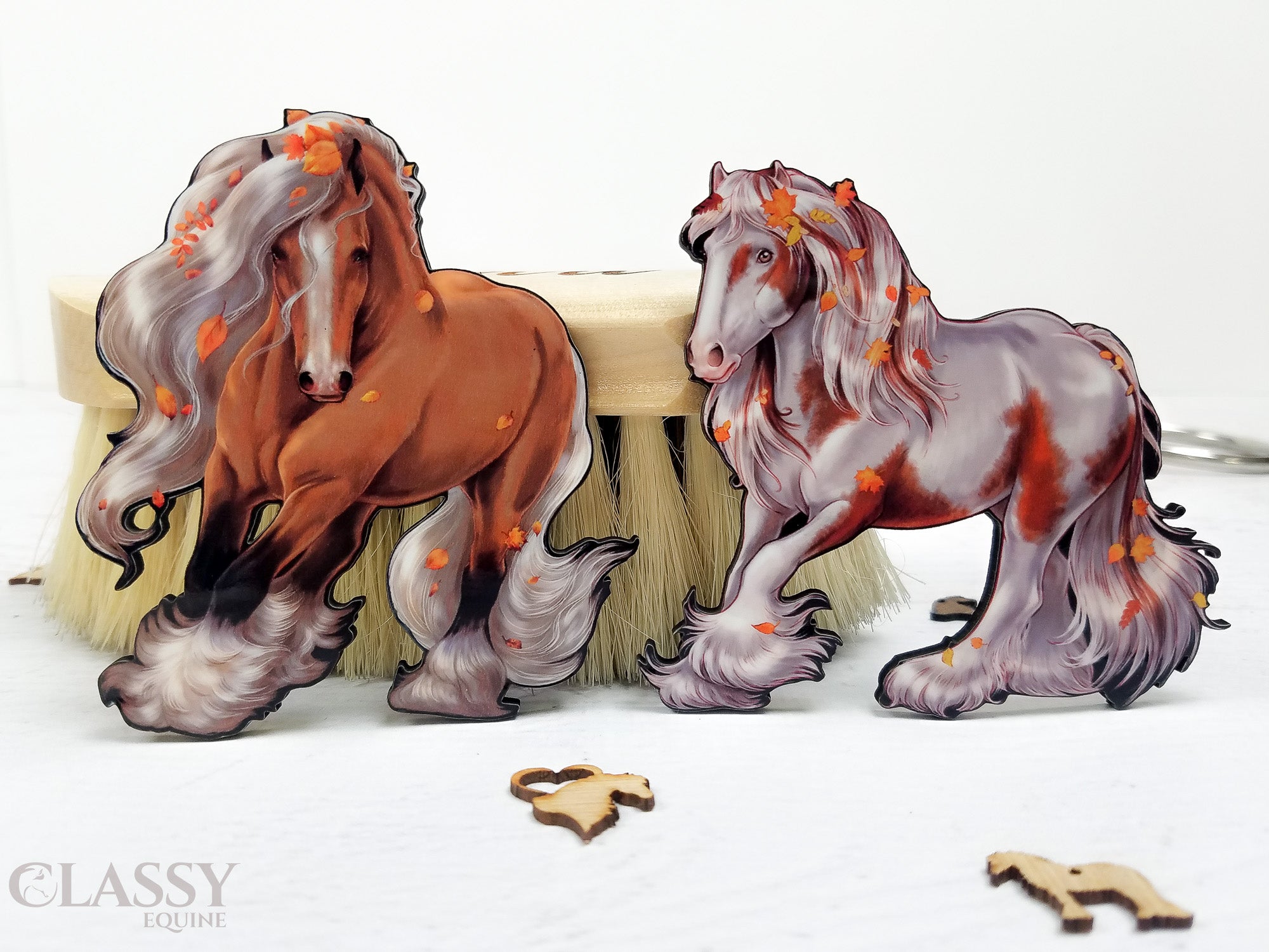 Set of two handmade Autumn Gypsy Horse ornaments, intricately designed and crafted from composite wood, featuring ribbons for hanging.