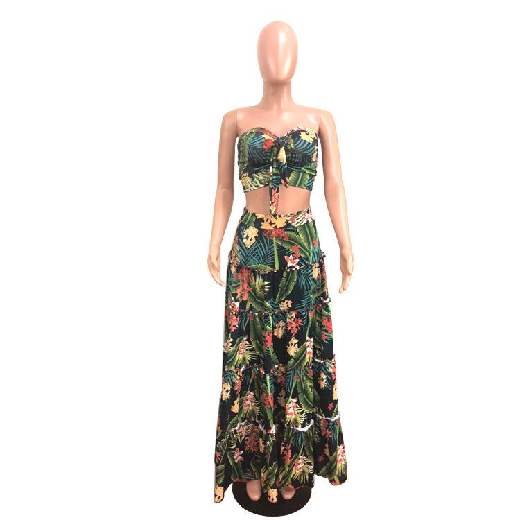A stylish two-piece dress set featuring a strapless top and a tropical wrap skirt in vibrant green, perfect for summer outings.