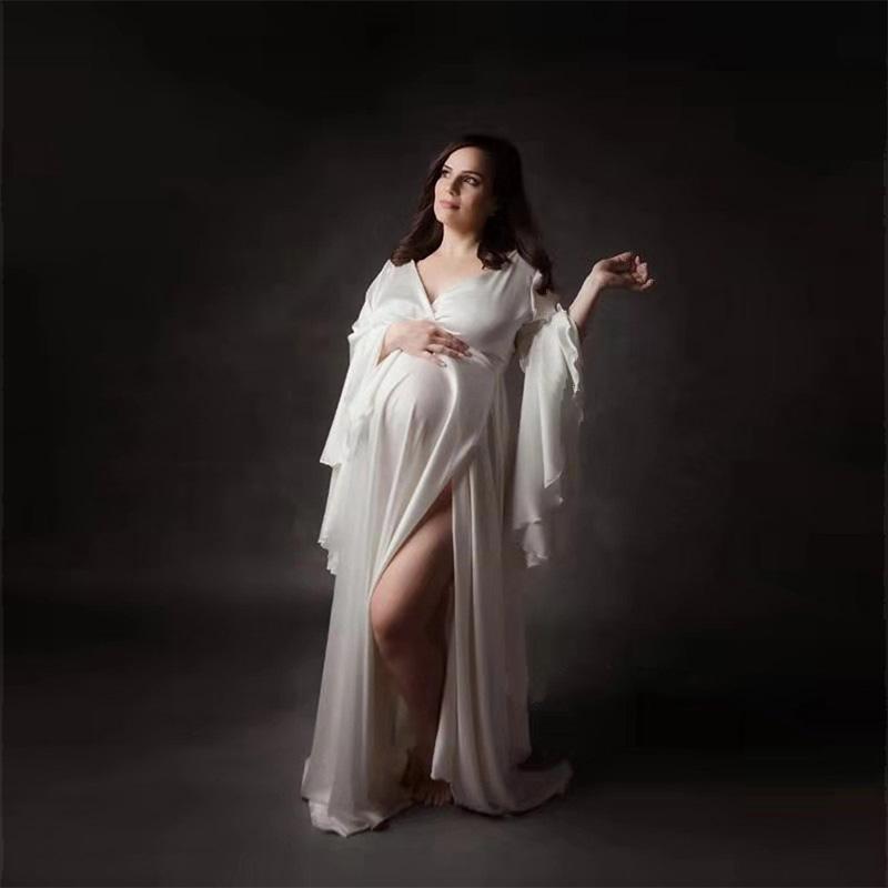 A beautiful pregnant woman wearing a Sexy V neck Pregnancy Dress with a split front design, showcasing elegance and comfort for maternity photoshoots.