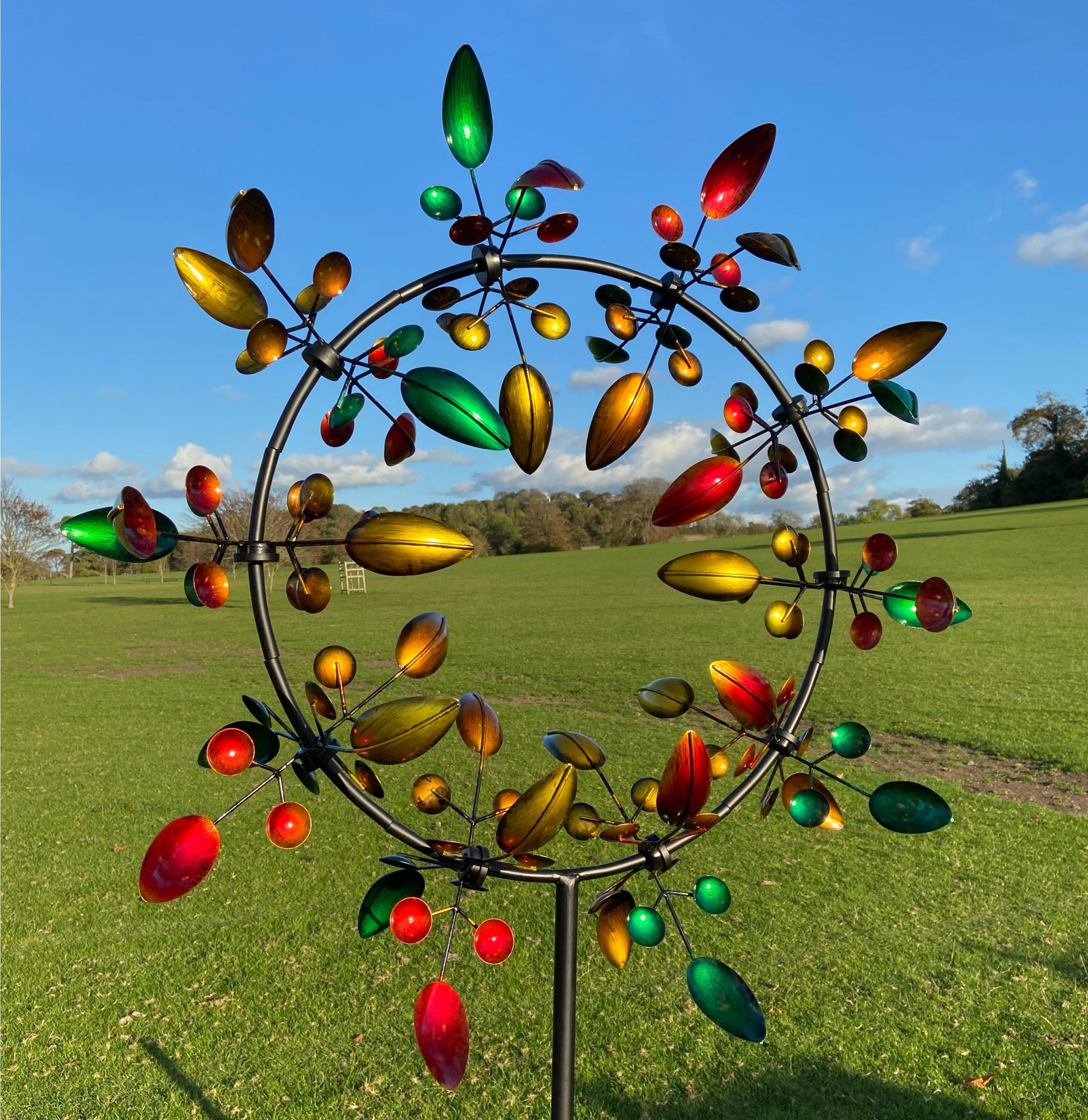 Sherborne garden wind sculpture spinner featuring autumnal leaves, standing 2.4m tall with vibrant colors and intricate design.