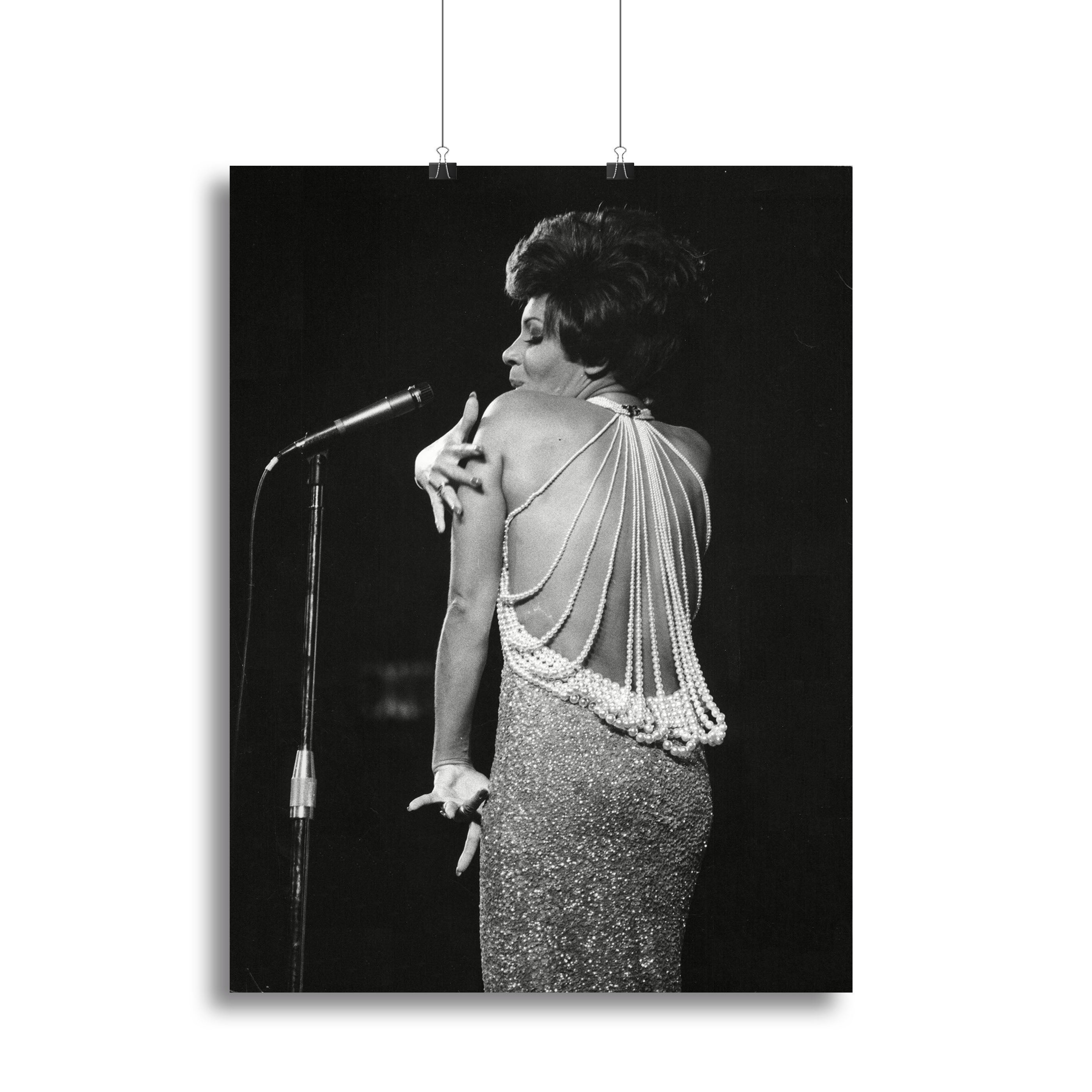 Shirley Bassey performing on stage, captured in a vibrant canvas print or poster, showcasing her powerful presence and elegance.