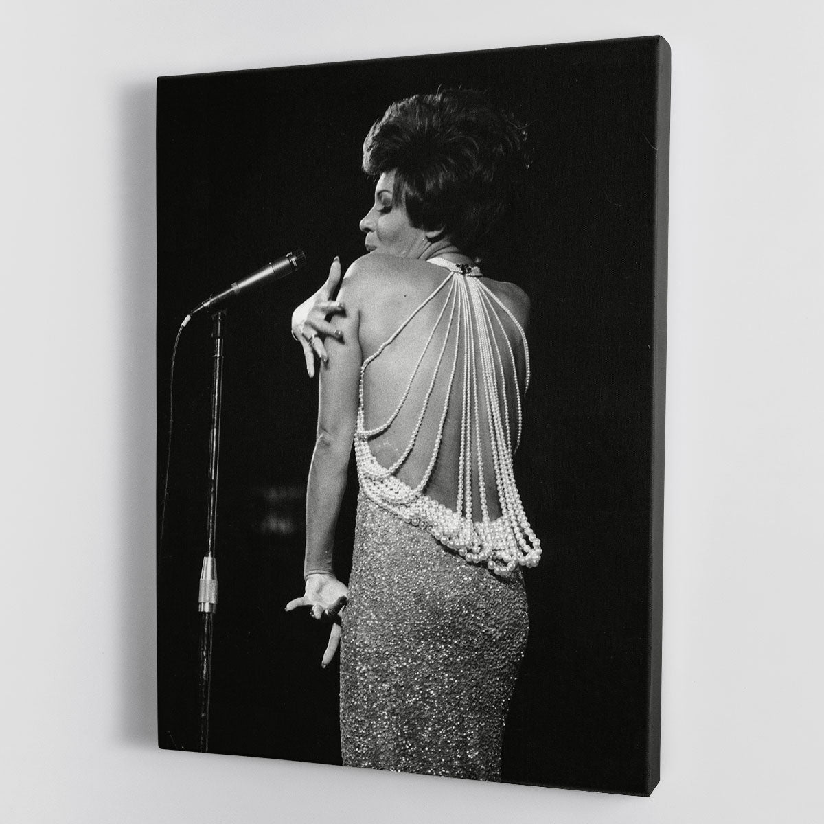 Shirley Bassey performing on stage, captured in a vibrant canvas print or poster, showcasing her powerful presence and elegance.