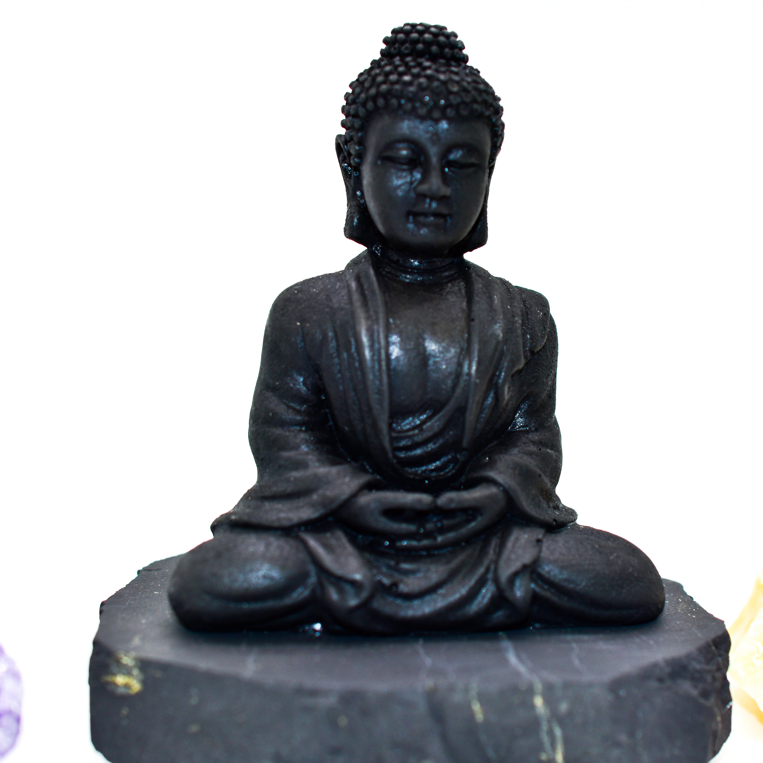 A natural Shungite Buddha figurine sitting gracefully, showcasing its unique texture and dark color, perfect for EMF protection.