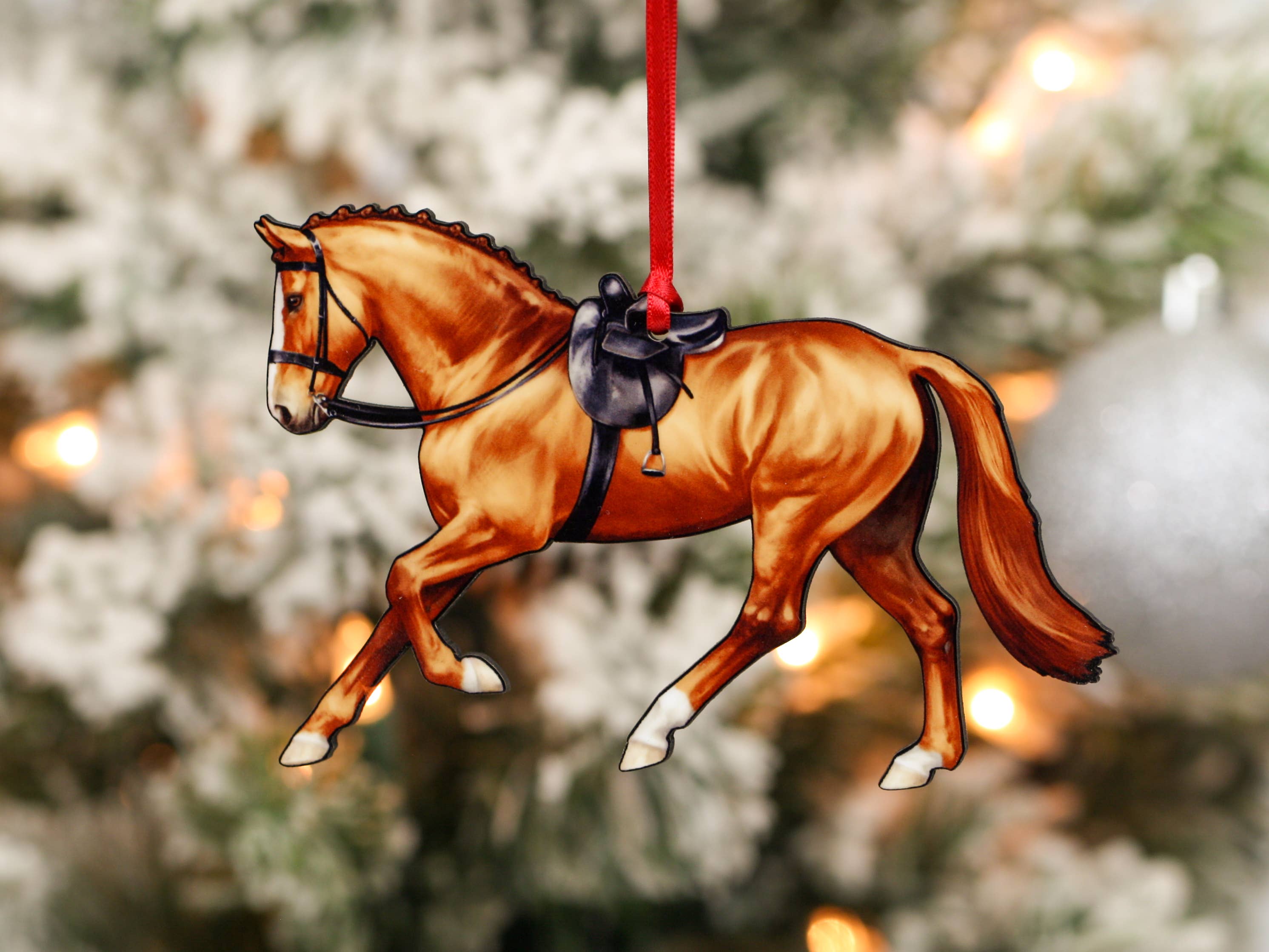 A beautifully crafted Side Saddle Horse Ornament in chestnut color, made from composite wood with a glossy finish, perfect for Christmas decoration.