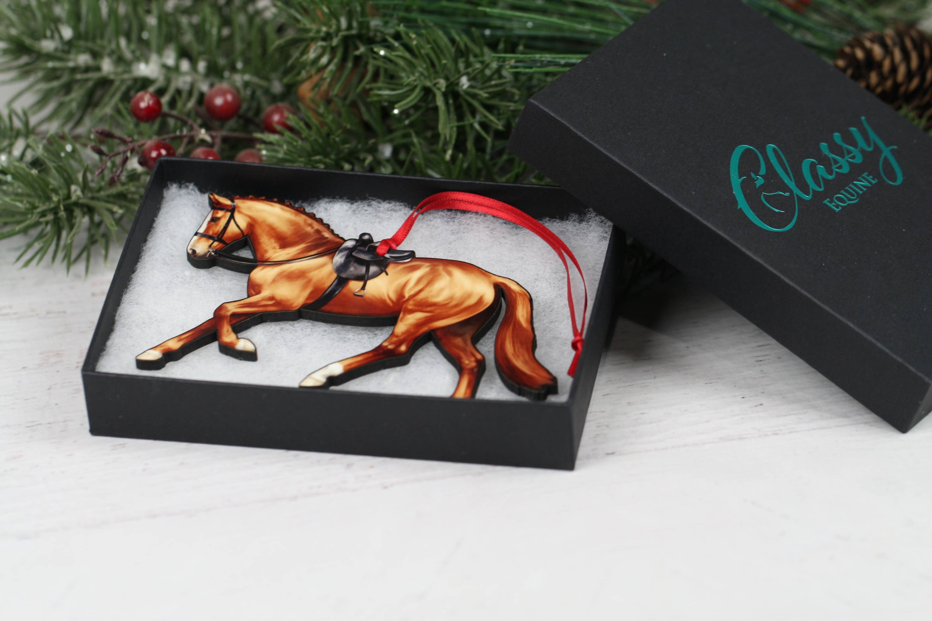 A beautifully crafted Side Saddle Horse Ornament in chestnut color, made from composite wood with a glossy finish, perfect for Christmas decoration.