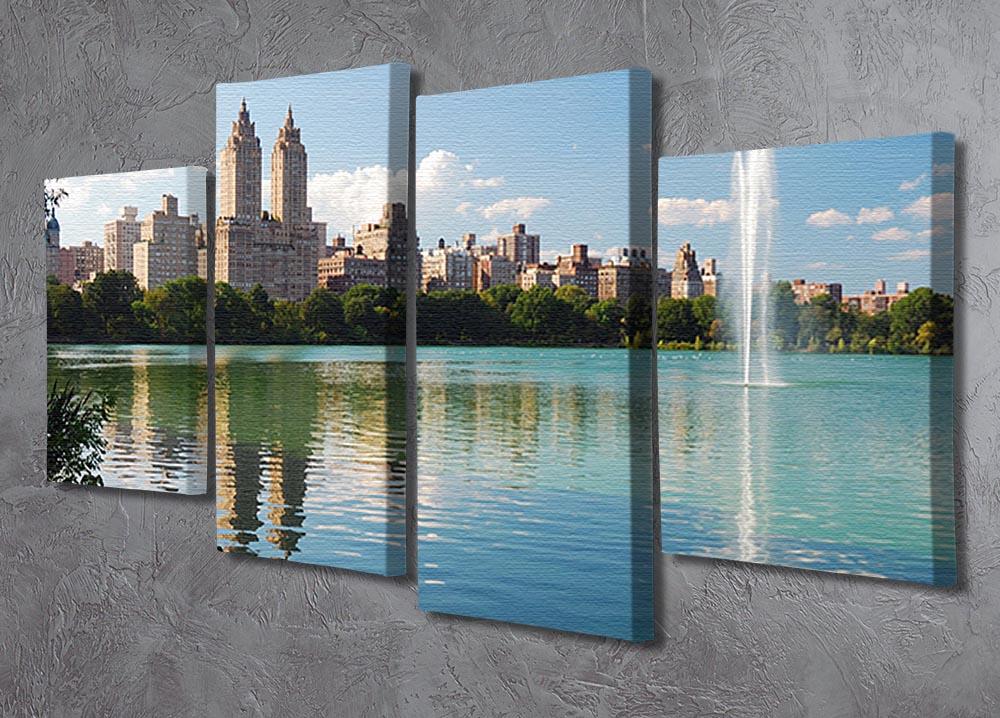 A beautiful 4 split panel canvas artwork depicting a skyline with skyscrapers and trees reflecting on a serene lake.