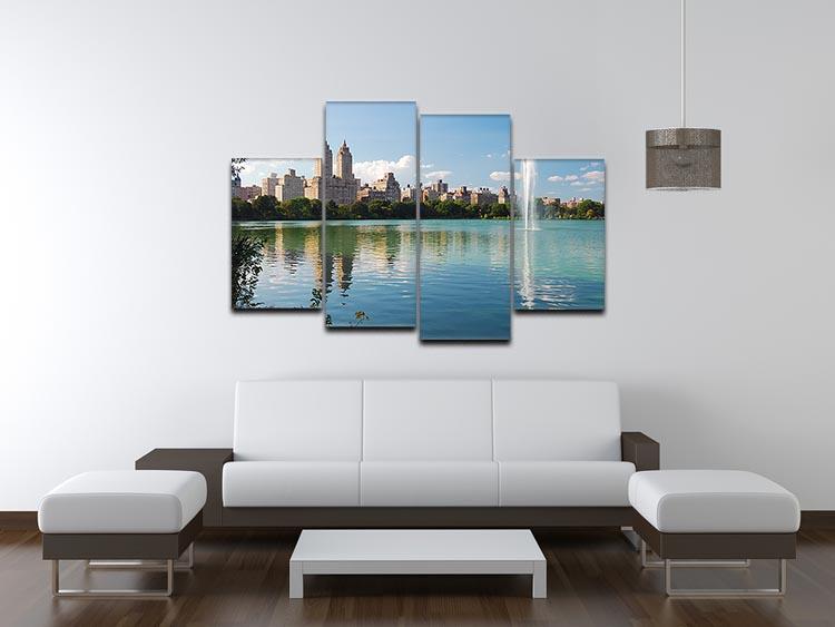 A beautiful 4 split panel canvas artwork depicting a skyline with skyscrapers and trees reflecting on a serene lake.