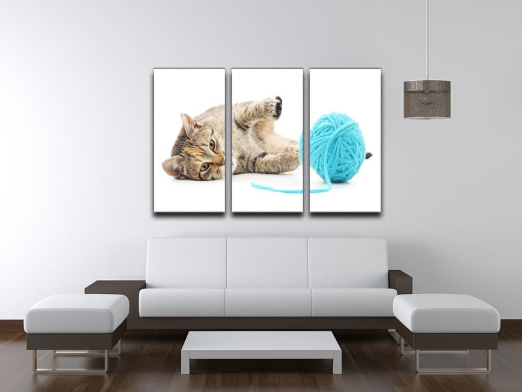 A charming 3-panel canvas print featuring a small funny kitten playing with a colorful clew of thread, perfect for home decor.