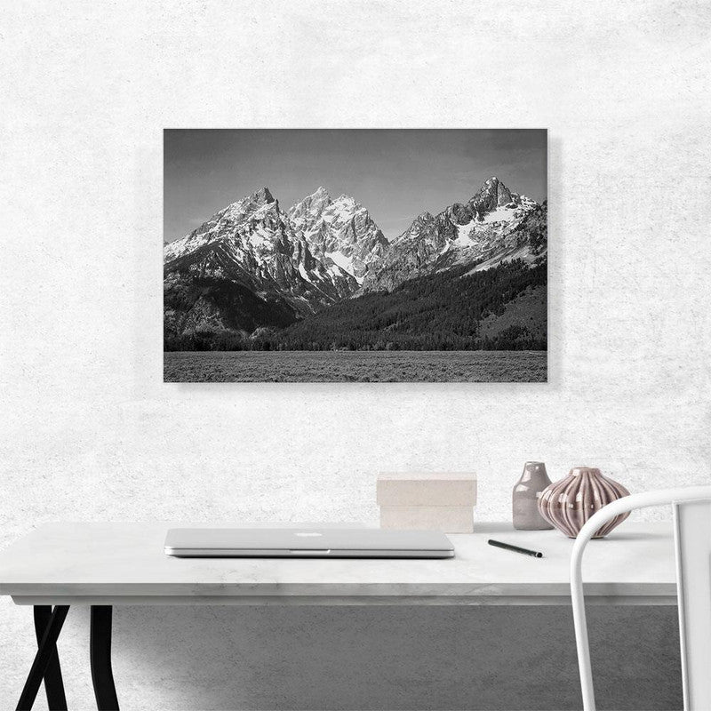 A stunning canvas print of the Snow Covered Peaks in Grand Teton National Park, showcasing majestic mountains covered in snow under a clear blue sky.