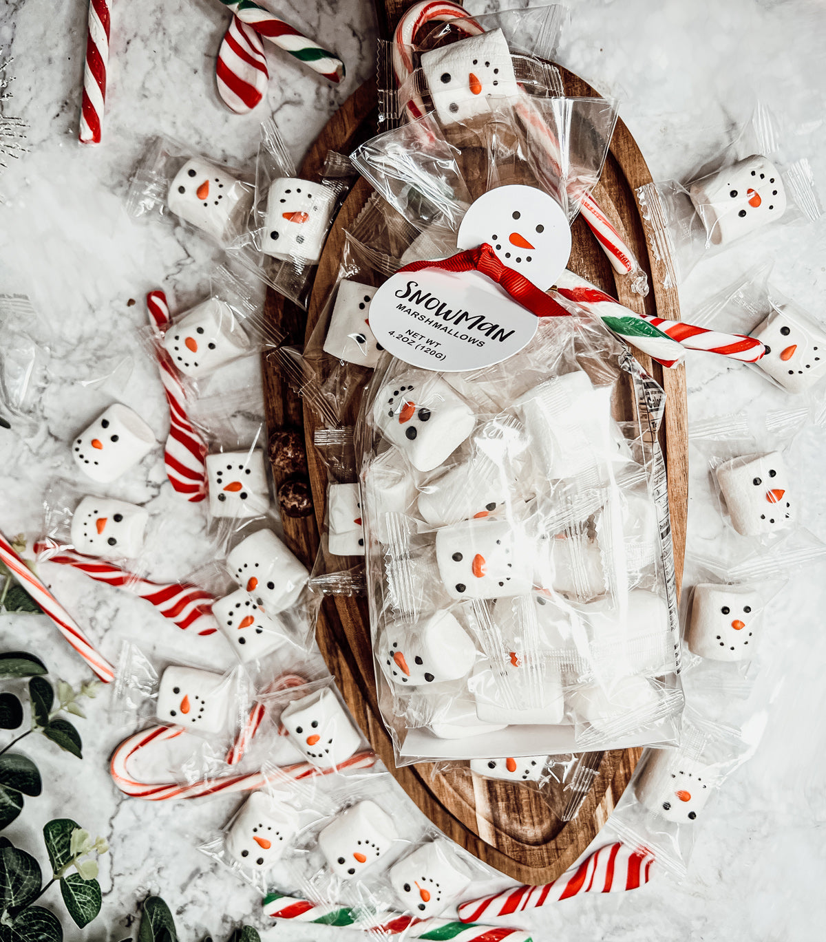 A pack of Snowman Marshmallows featuring fluffy, vanilla-flavored marshmallows shaped like snowmen, individually wrapped for freshness.