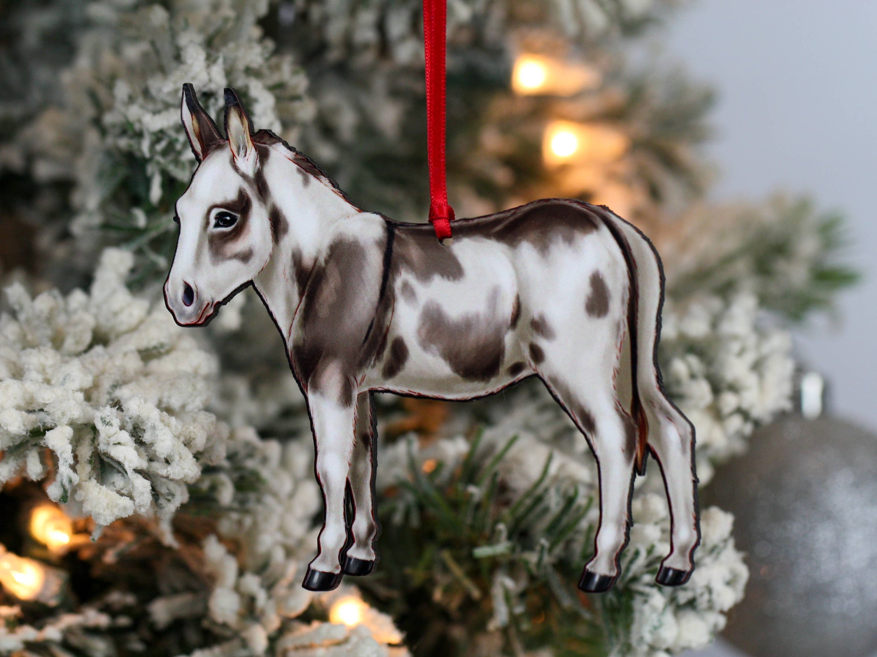 Spotted gray and white Miniature Donkey ornament made from composite wood, featuring a glossy front and dark brown back, perfect for Christmas decor.