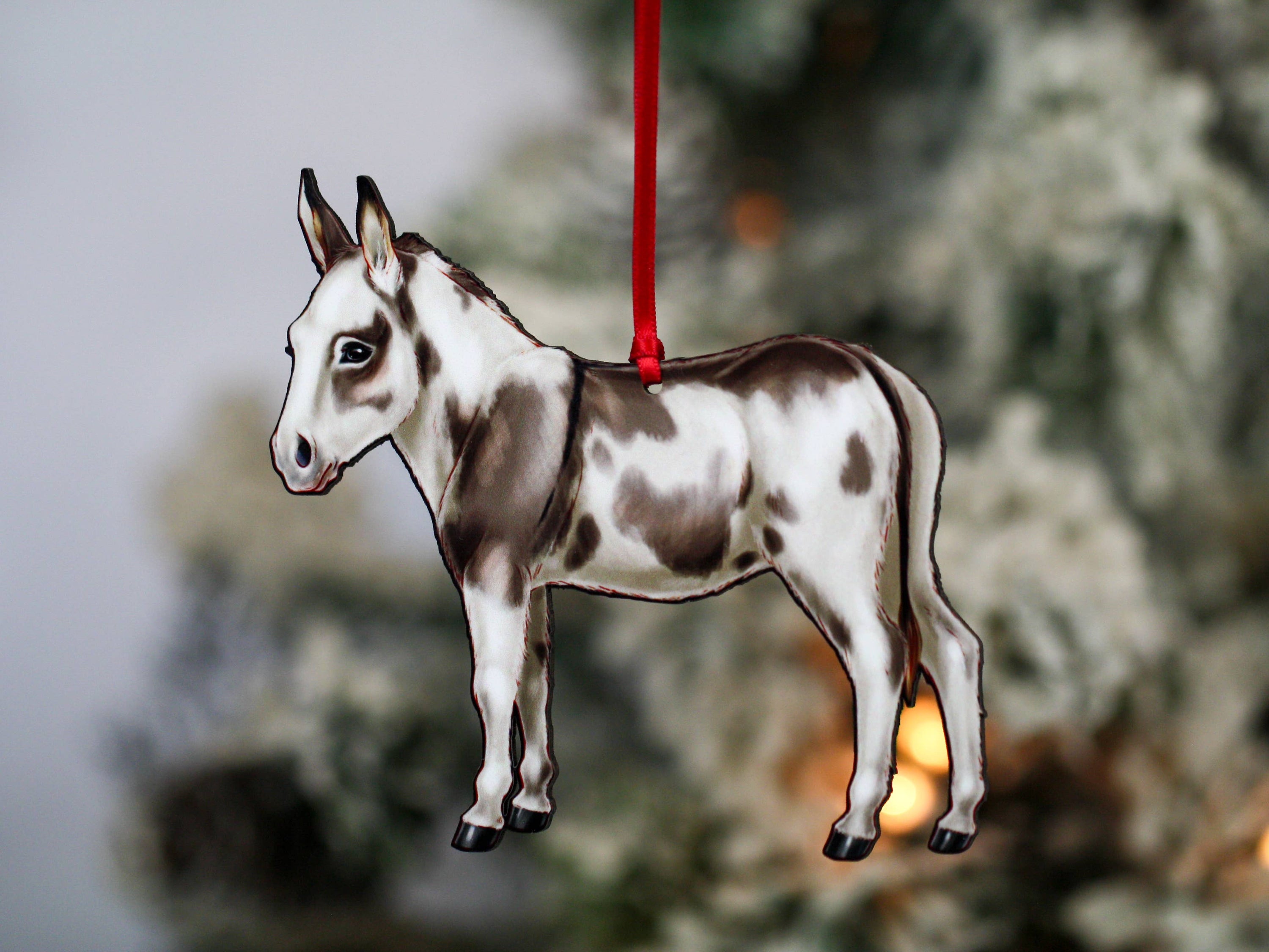 Spotted gray and white Miniature Donkey ornament made from composite wood, featuring a glossy front and dark brown back, perfect for Christmas decor.
