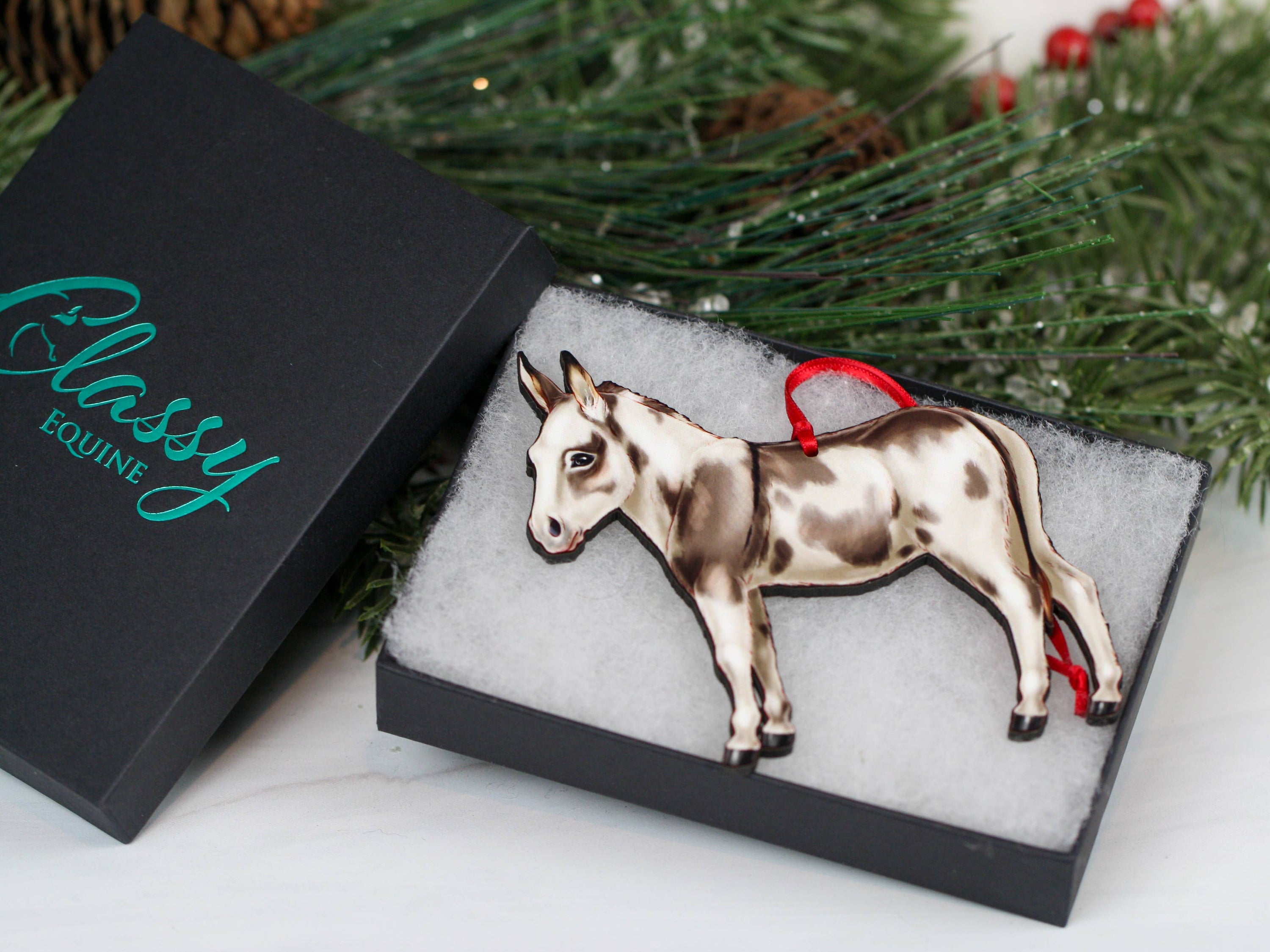 Spotted gray and white Miniature Donkey ornament made from composite wood, featuring a glossy front and dark brown back, perfect for Christmas decor.