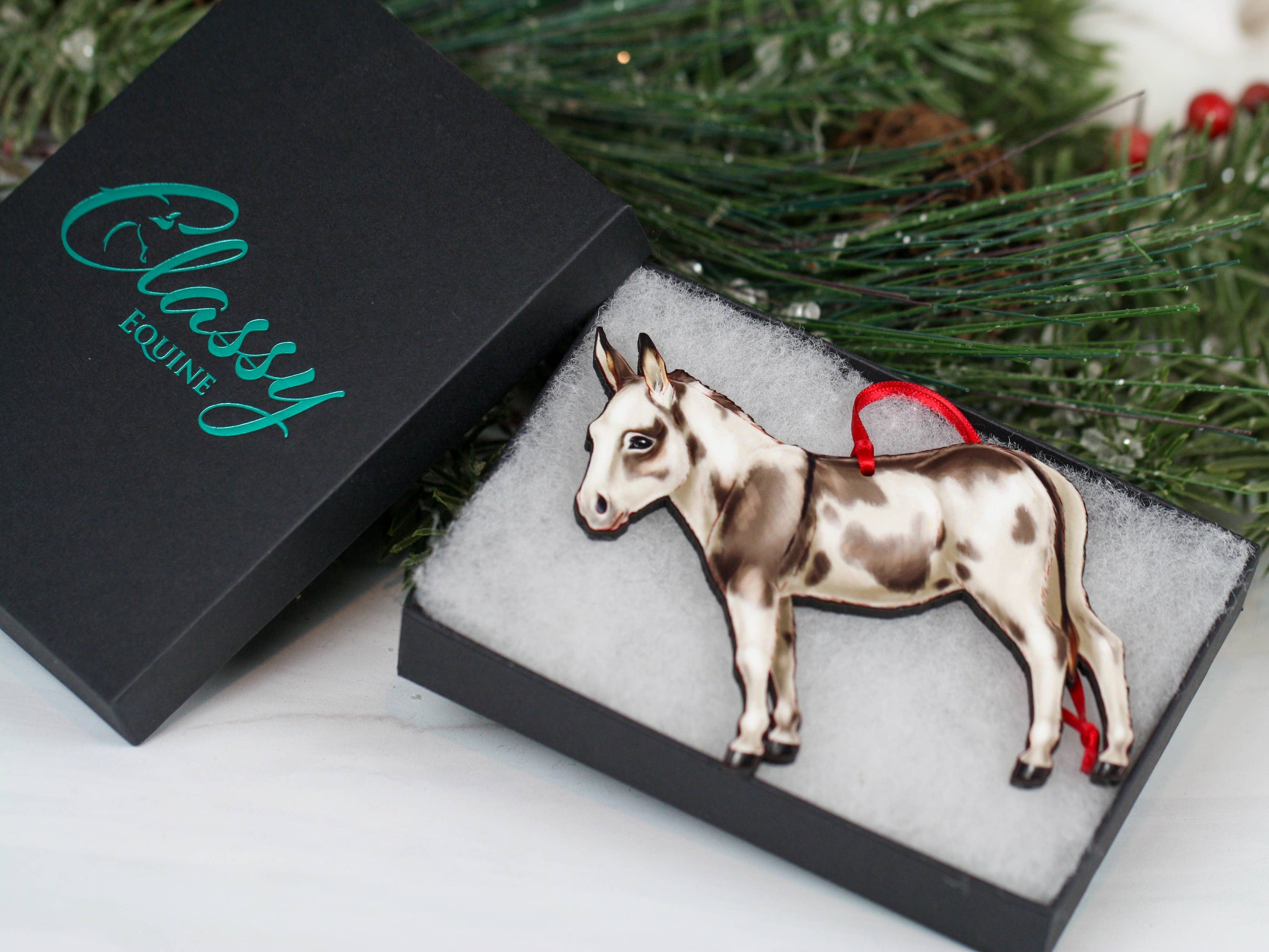 Spotted gray and white Miniature Donkey ornament made from composite wood, featuring a glossy front and dark brown back, perfect for Christmas decor.