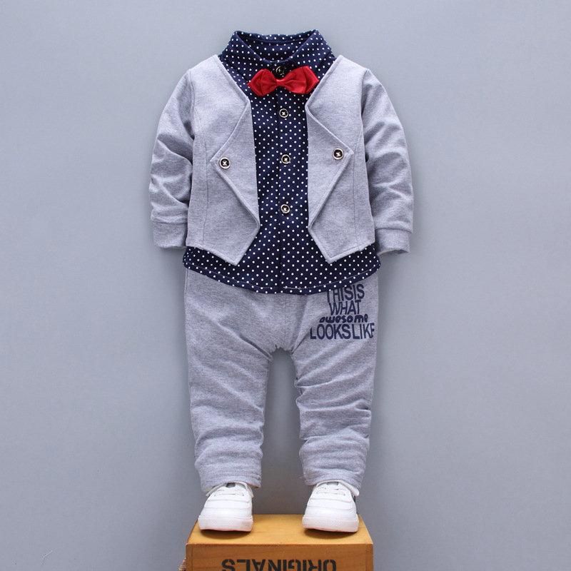 A stylish set of spring autumn clothing for children, featuring a long-sleeve top and pants in a trendy patchwork design, suitable for boys and girls.