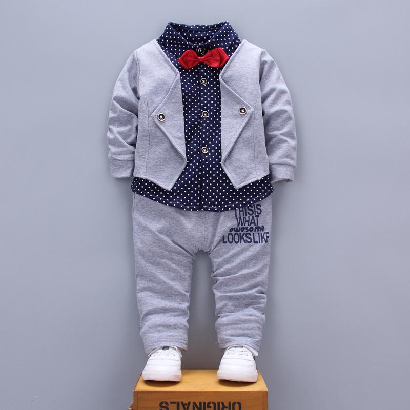 A stylish set of spring autumn clothing for children, featuring a long-sleeve top and pants in a trendy patchwork design, suitable for boys and girls.