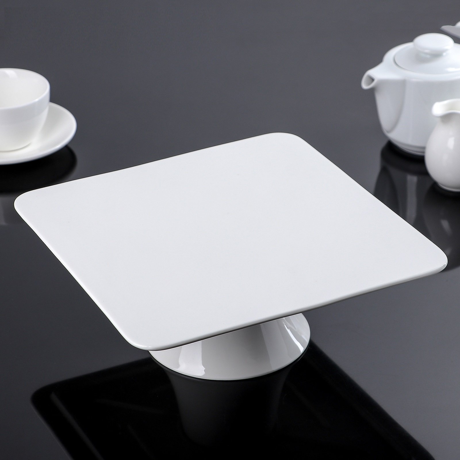 Elegant 12-inch square white porcelain cake stand, perfect for displaying cakes and desserts.