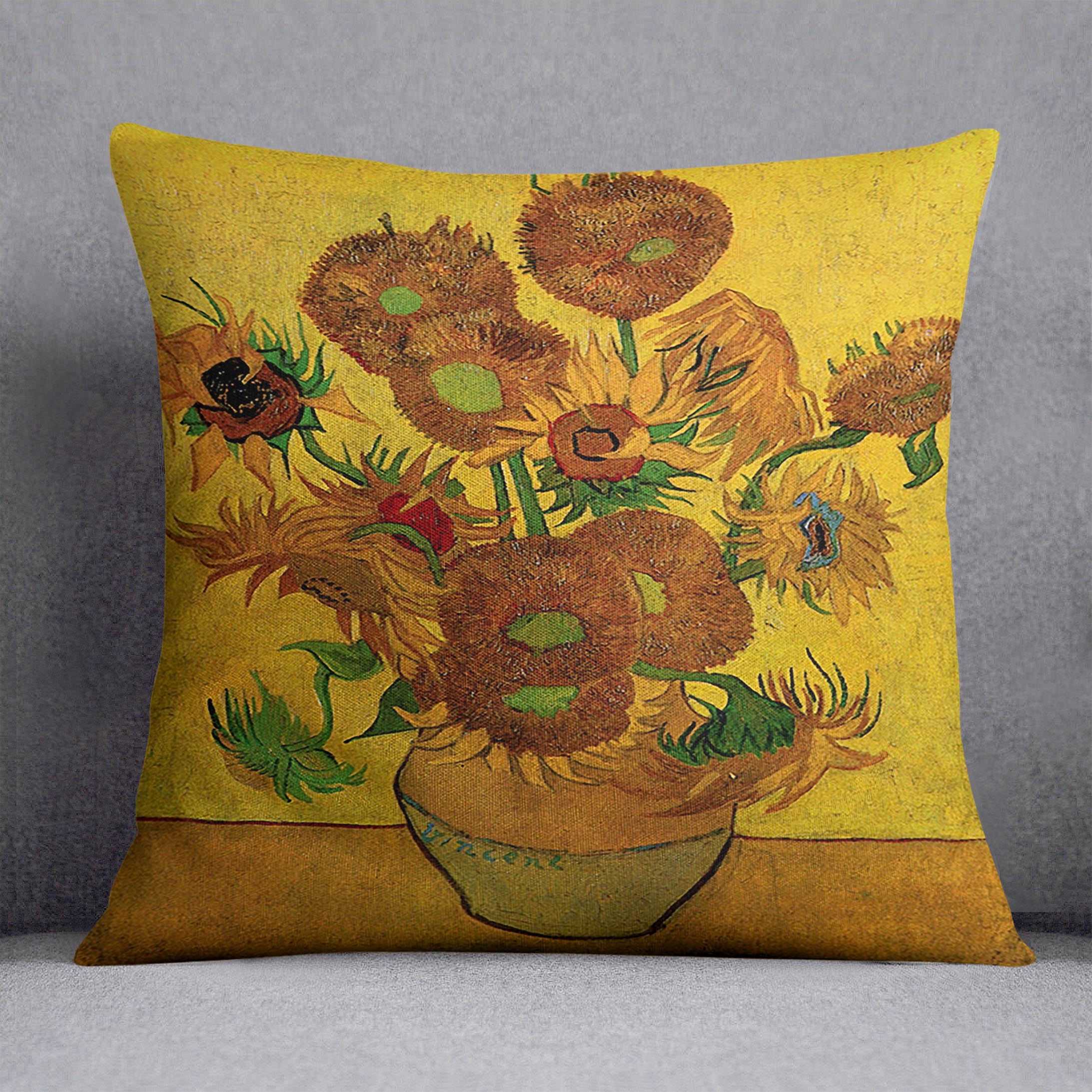 A vibrant cushion featuring Van Gogh's Still Life Vase with Fifteen Sunflowers design, made from luxurious vegan faux suede.