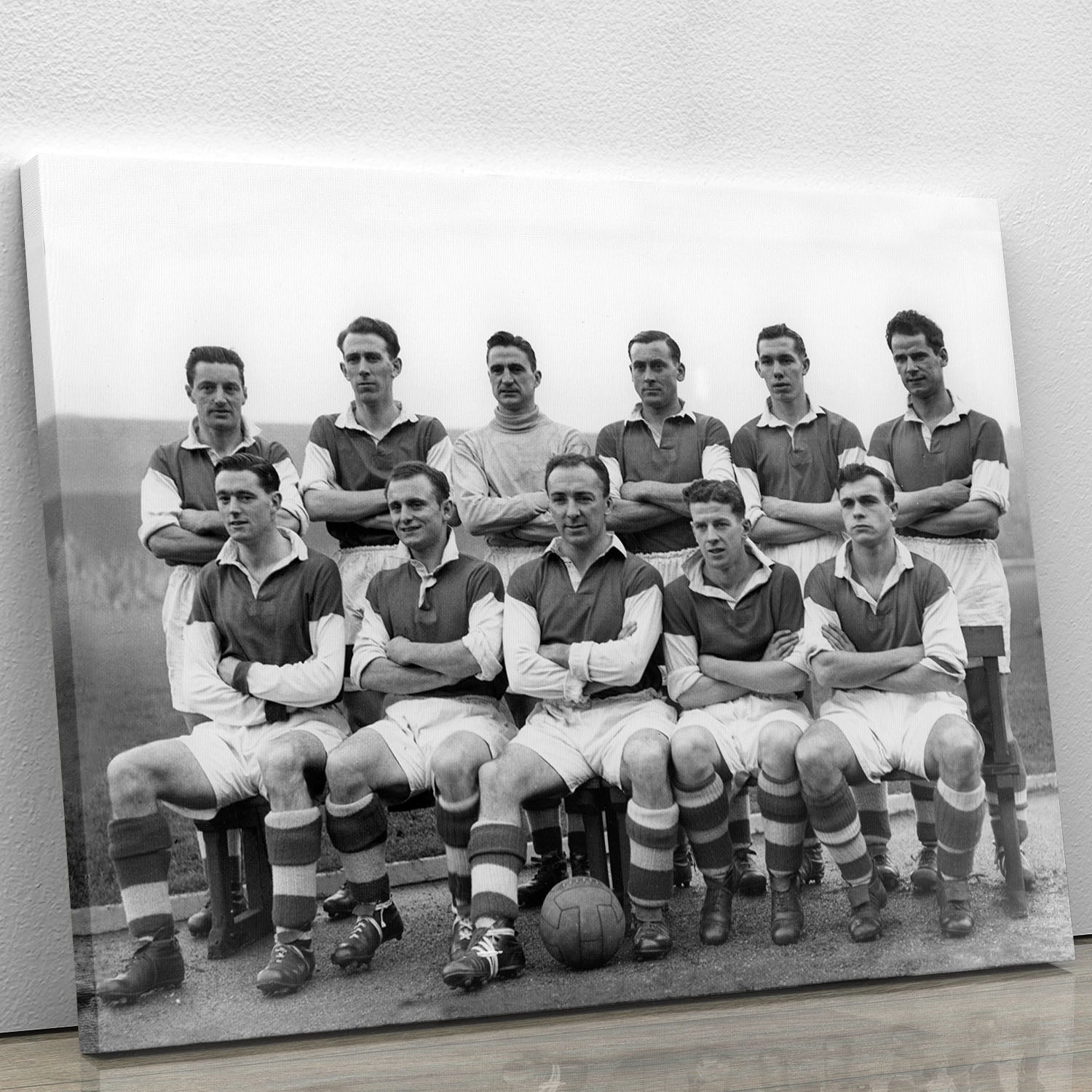A vintage 1954 team photo of Stirling Albion Football Club displayed on a canvas print, showcasing players in their classic football kits.
