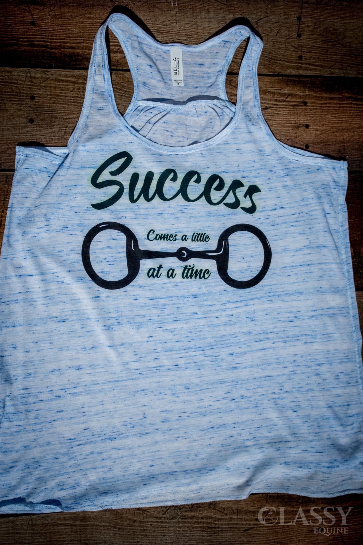 Flowy tank top with 'Success Comes a Little Bit at a Time' design in blue marble color, showcasing a relaxed fit.