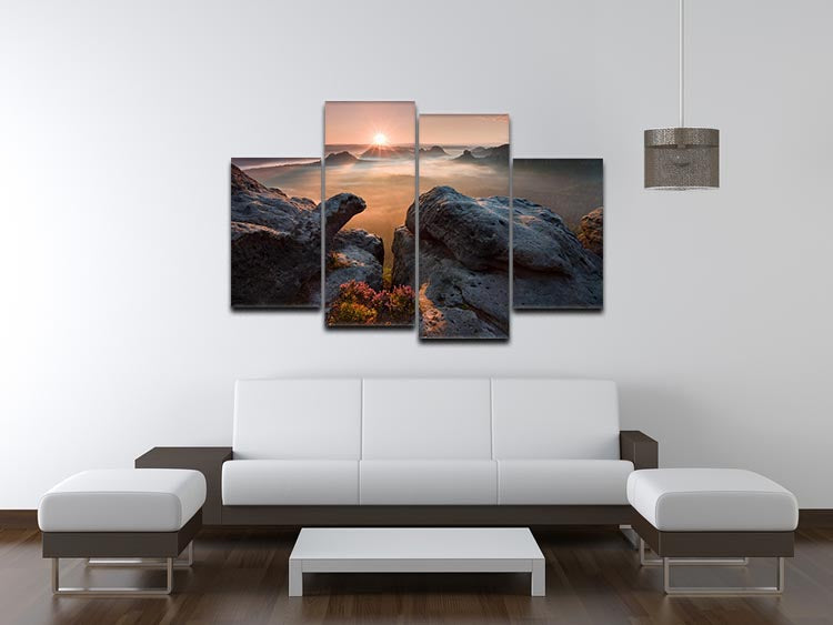 A vibrant 4-split canvas artwork depicting a serene sunrise over rocky terrain, showcasing warm colors and dynamic design.