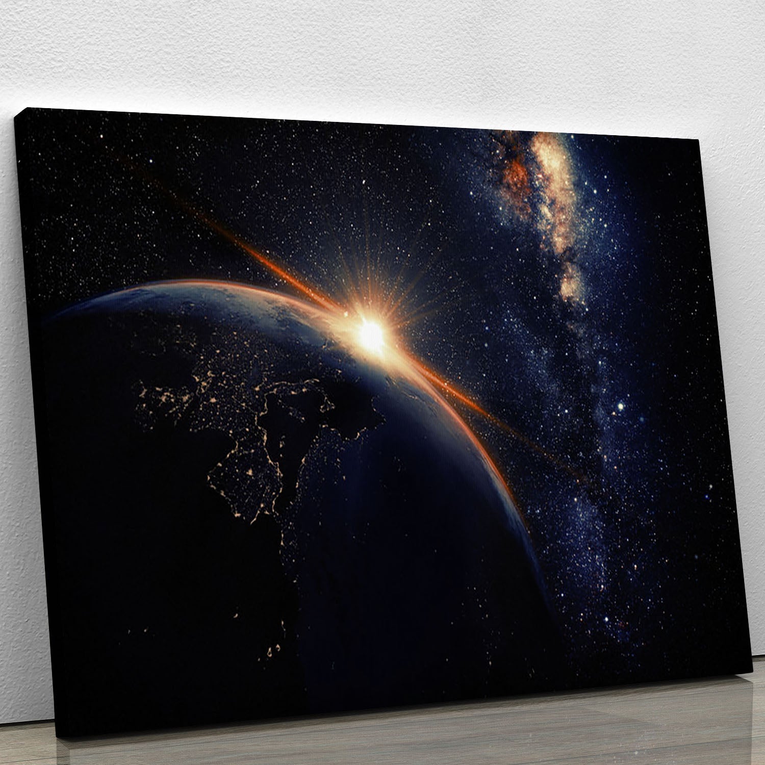 A stunning canvas print depicting a vibrant sunrise seen from space, showcasing the Earth and colorful clouds.