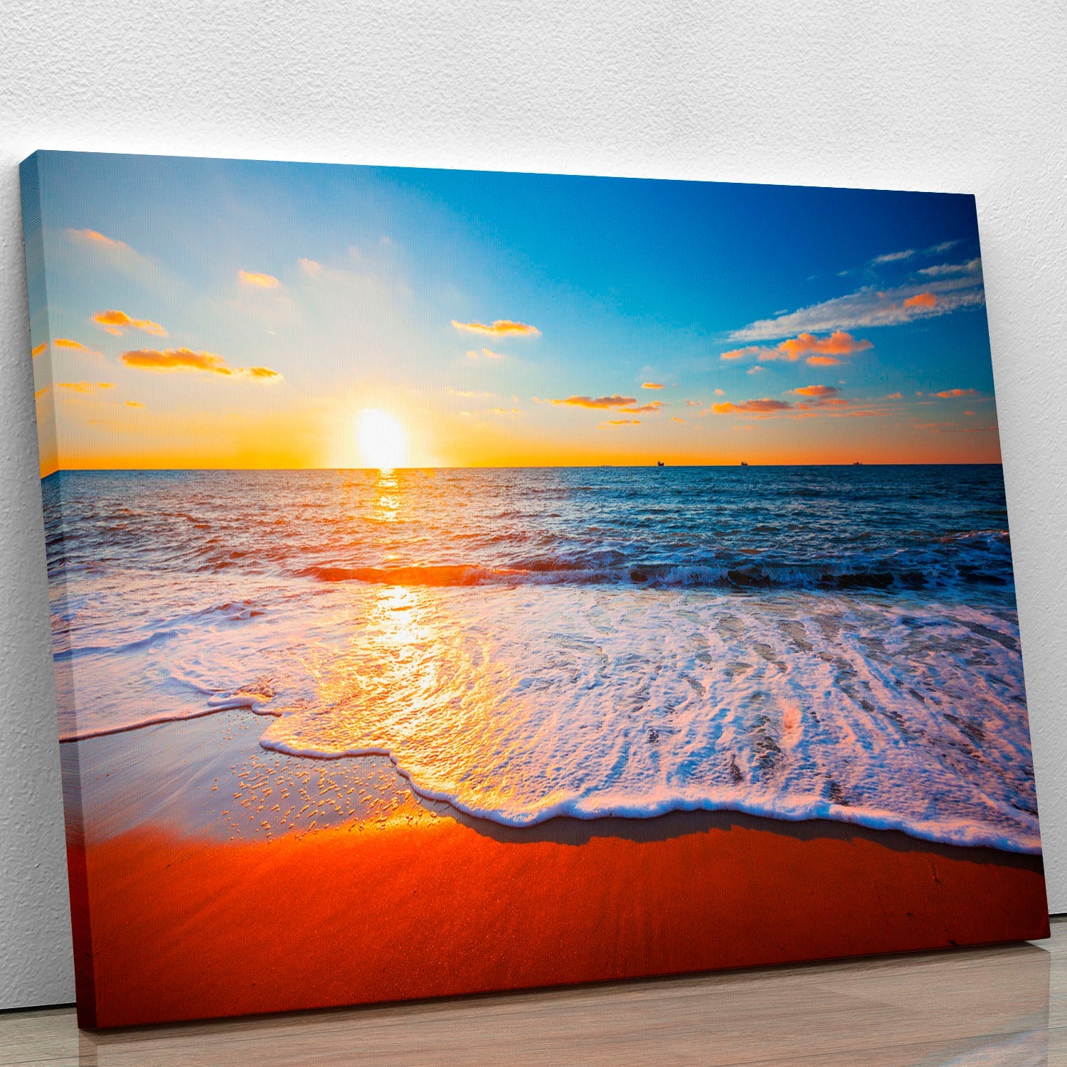 A beautiful canvas print featuring a vibrant sunset over a calm sea, showcasing rich colors and serene scenery.