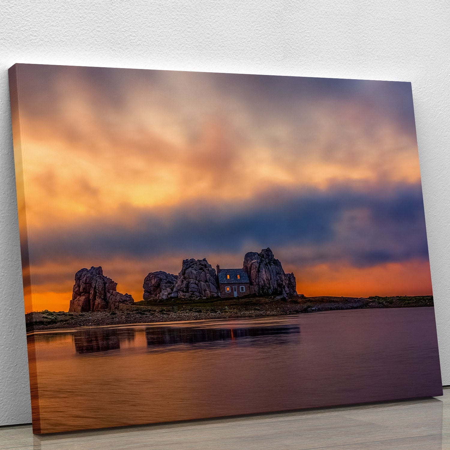 A beautiful canvas print of a sunset over Plougrescant, showcasing vibrant colors and serene landscape details.