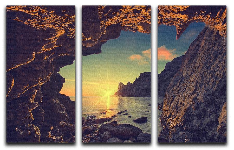 Three-panel canvas print depicting a sunset view from a mountain cave, showcasing vibrant colors and natural beauty.