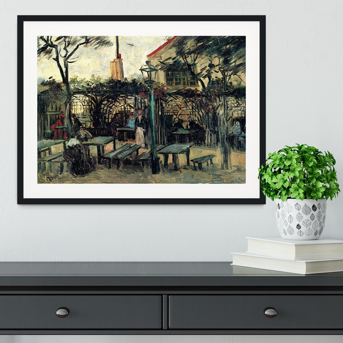 Framed artwork of Terrace of a Cafe on Montmartre La Guinguette1 by Van Gogh, showcasing vibrant colors and intricate details.