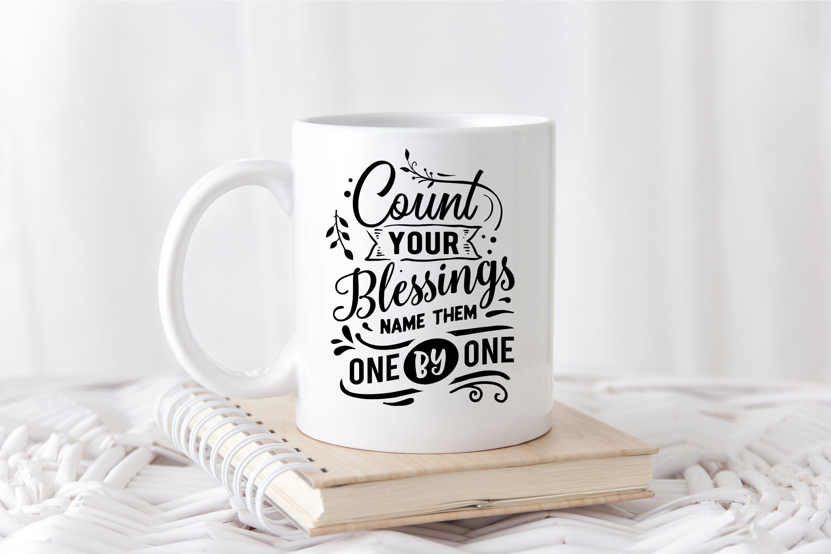 A beautifully designed Thanksgiving mug featuring the phrase 'Count Your Blessings' with autumn-themed decorations, available in two sizes.