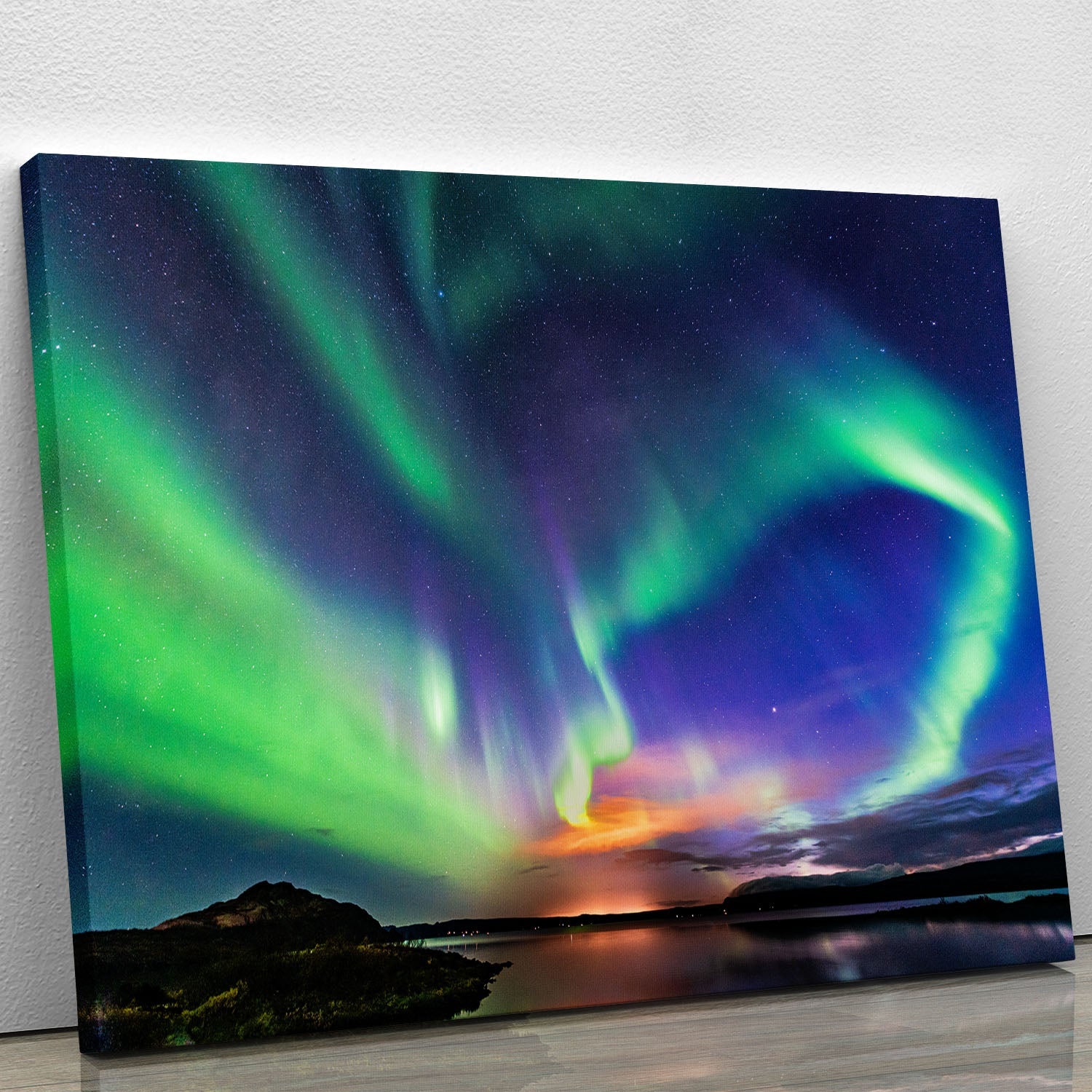 A vibrant canvas print of the aurora borealis over Iceland, showcasing colorful lights in the night sky above a serene landscape.