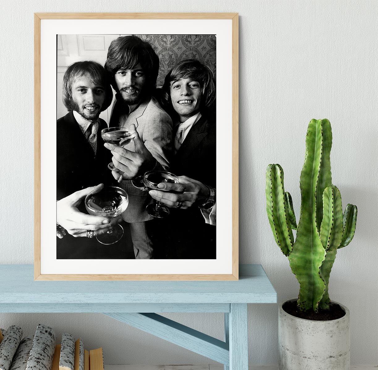A beautifully framed print of the Bee Gees, showcasing vibrant colors and high-quality craftsmanship in a stylish frame.