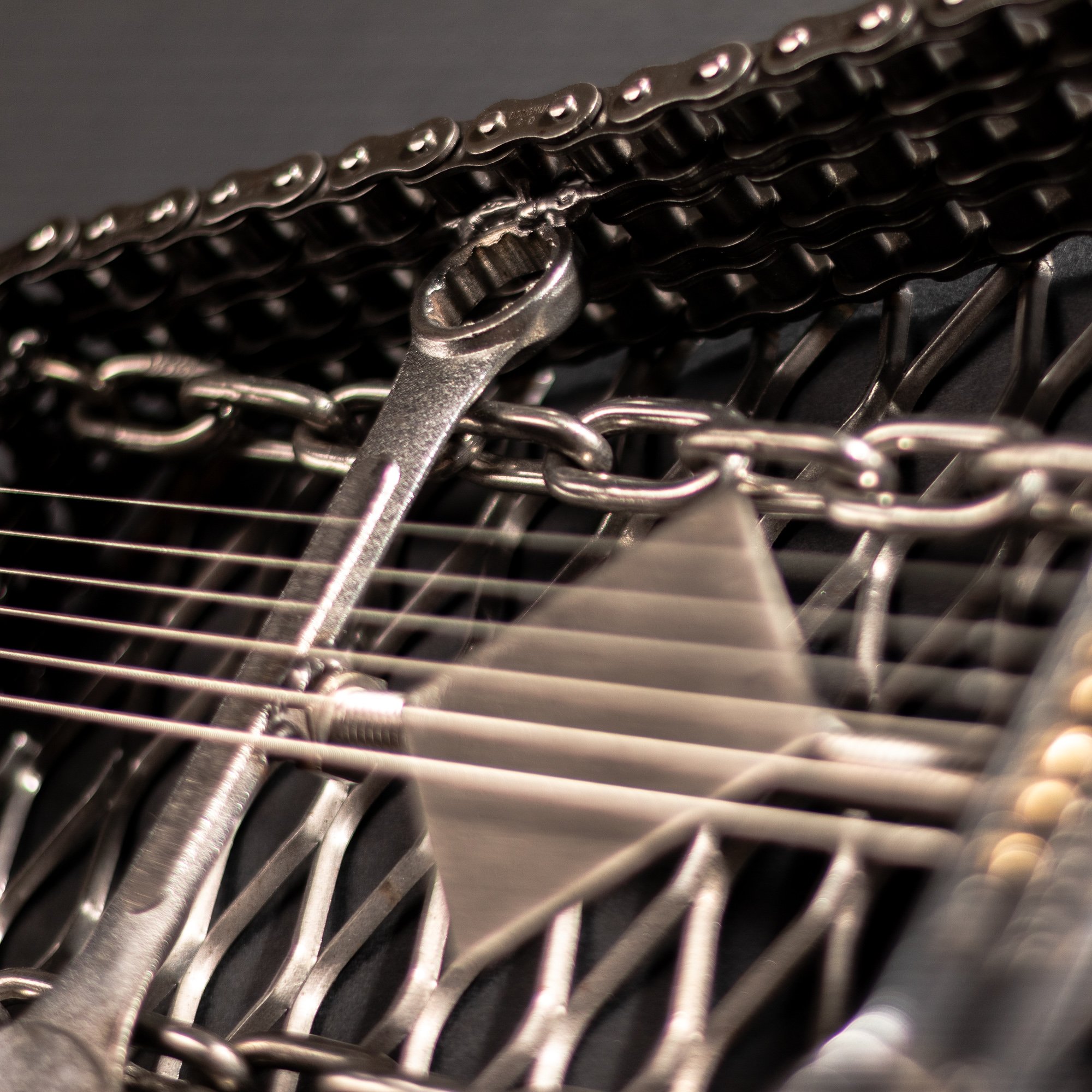 Handmade metal electric guitar sculpture, life-size, crafted from scrap metal with a clear finish.