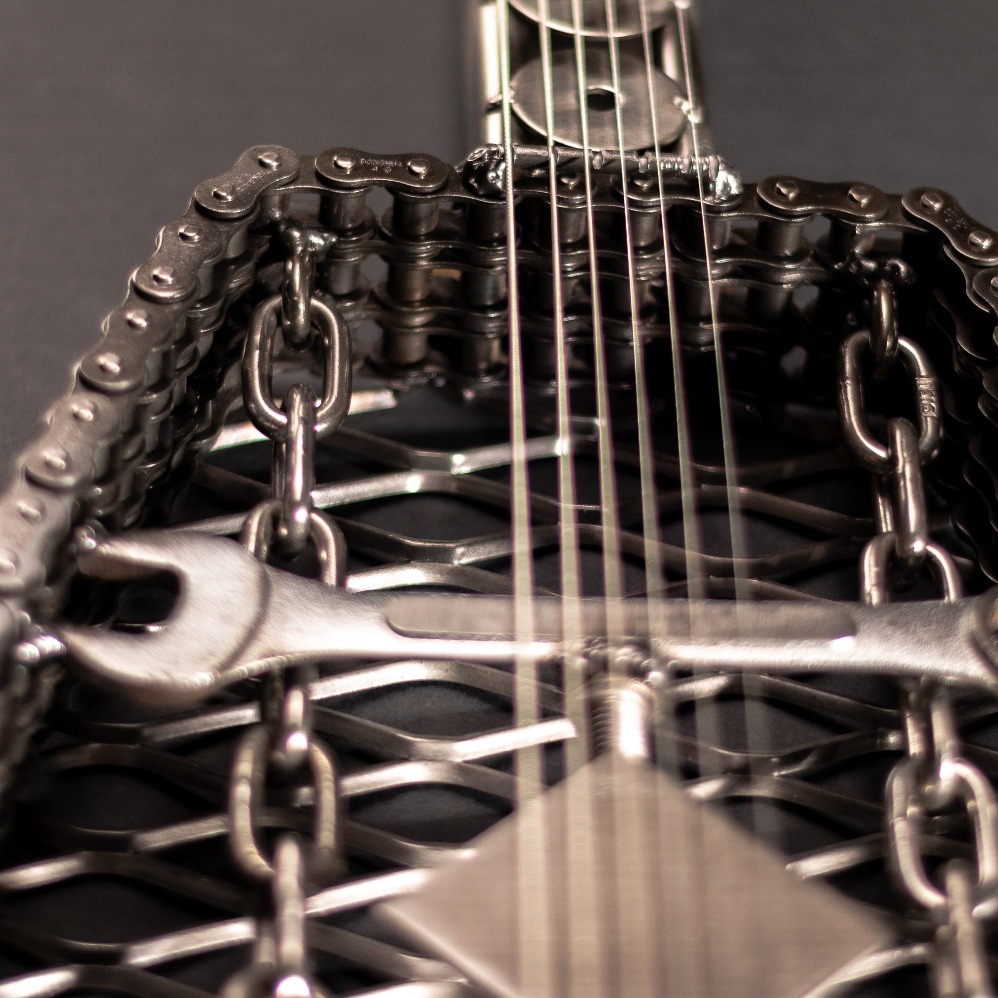 Handmade metal electric guitar sculpture, life-size, crafted from scrap metal with a clear finish.