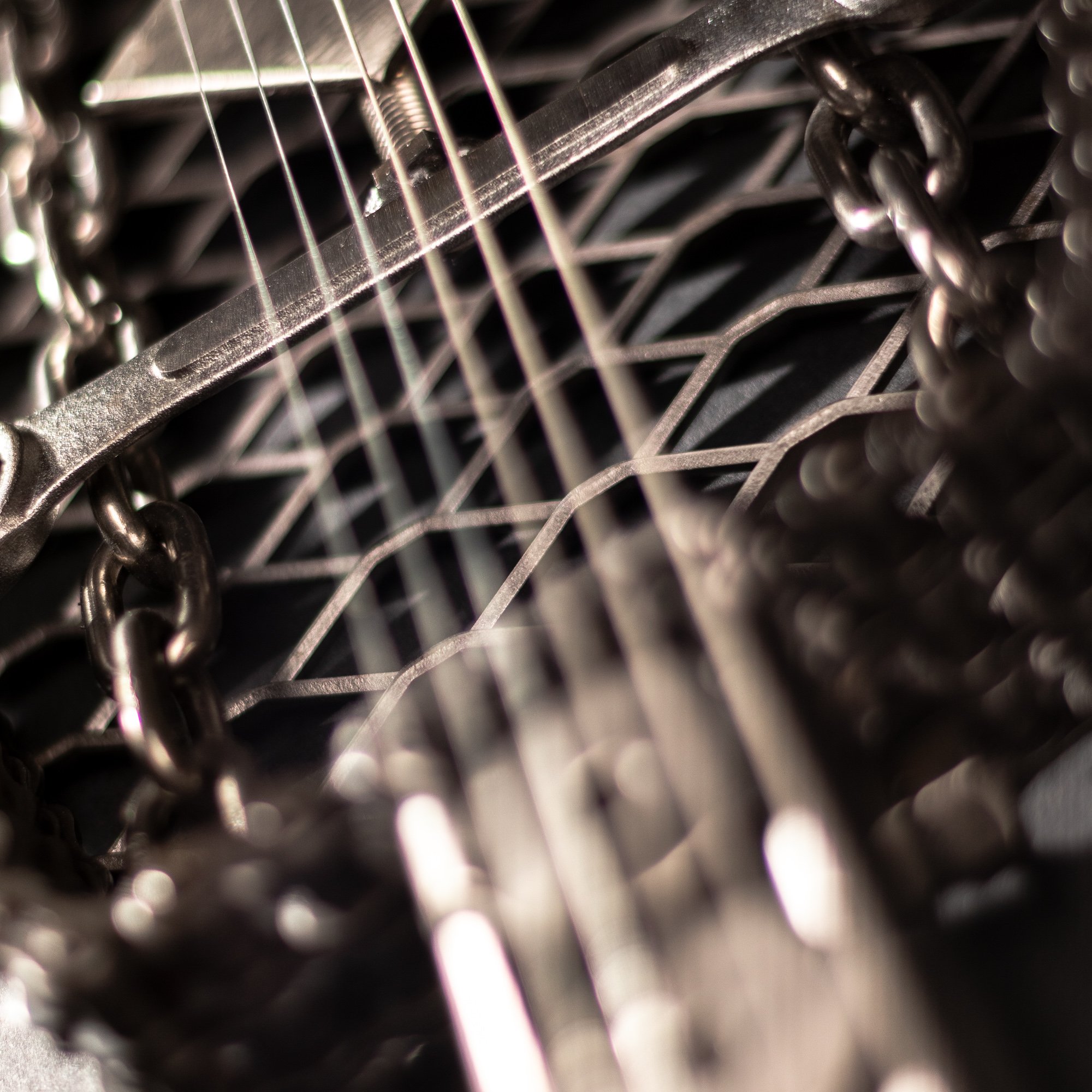 Handmade metal electric guitar sculpture, life-size, crafted from scrap metal with a clear finish.