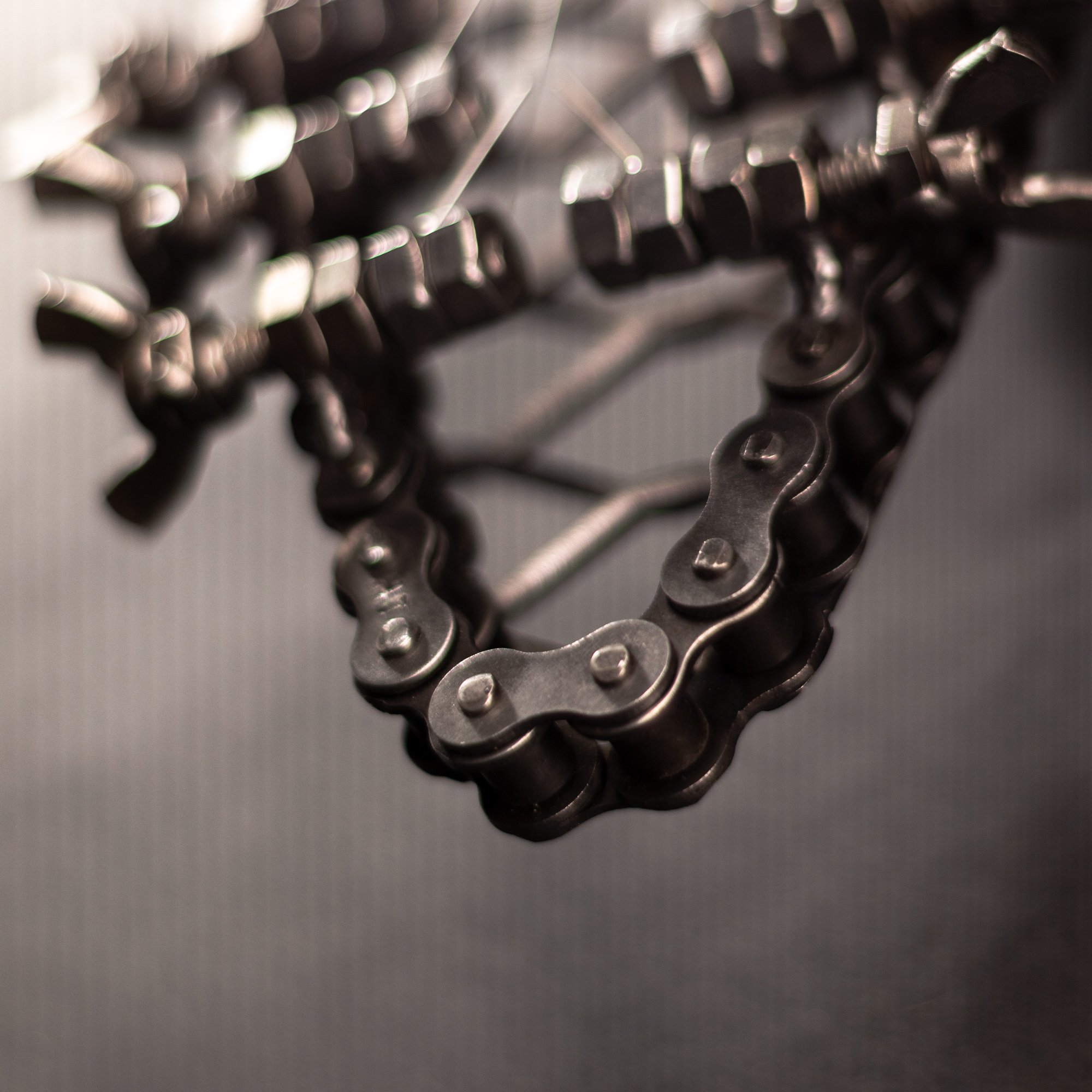 Handmade metal electric guitar sculpture, life-size, crafted from scrap metal with a clear finish.