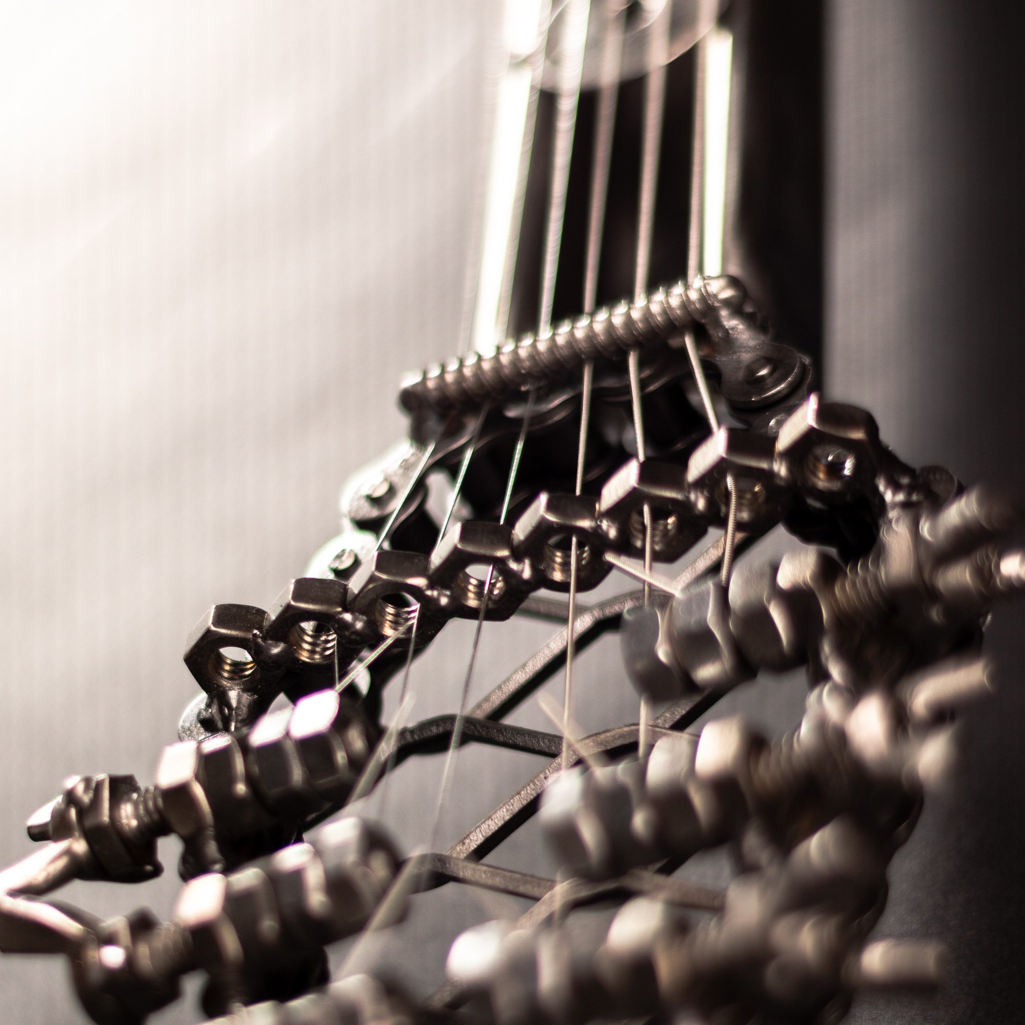 Handmade metal electric guitar sculpture, life-size, crafted from scrap metal with a clear finish.