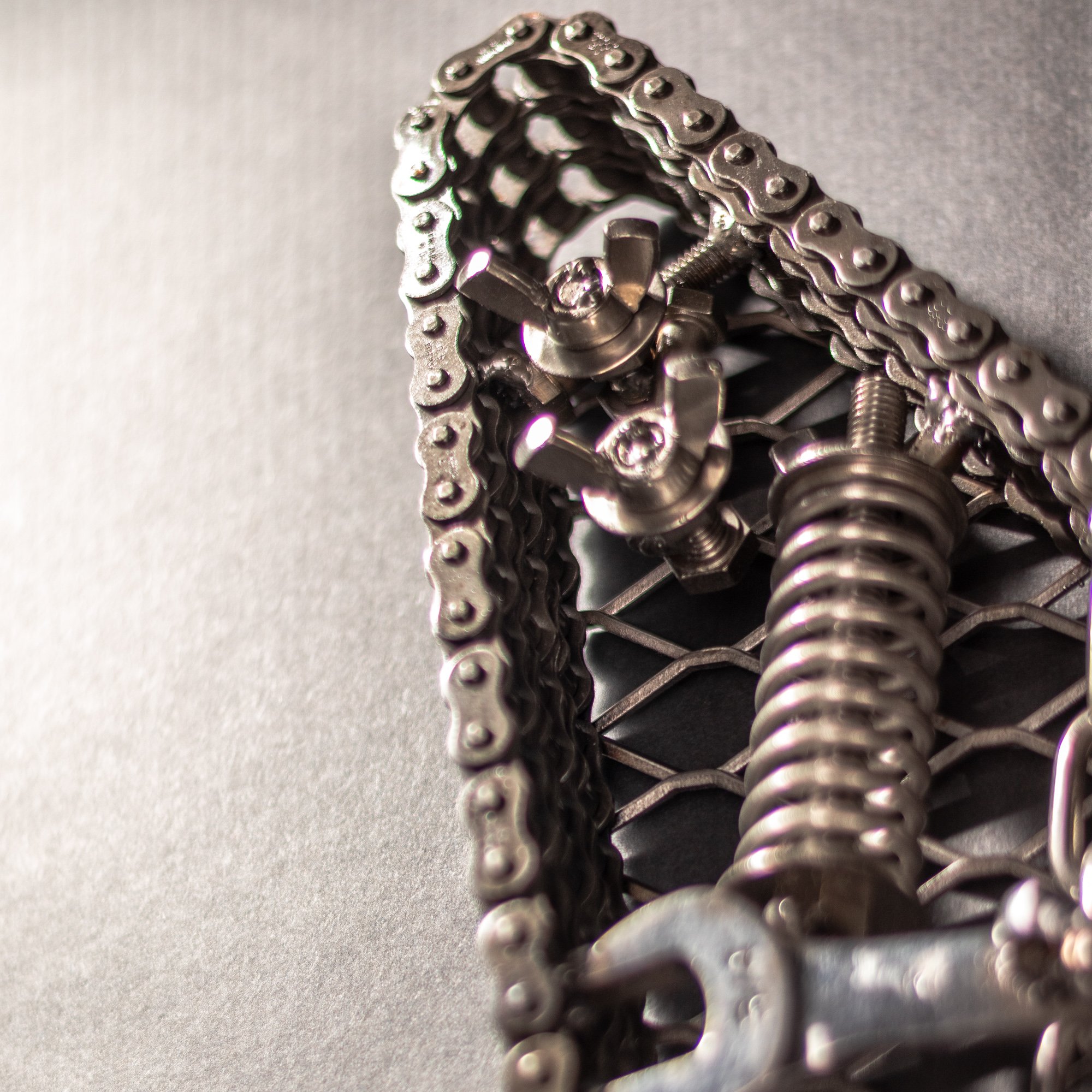 Handmade metal electric guitar sculpture, life-size, crafted from scrap metal with a clear finish.