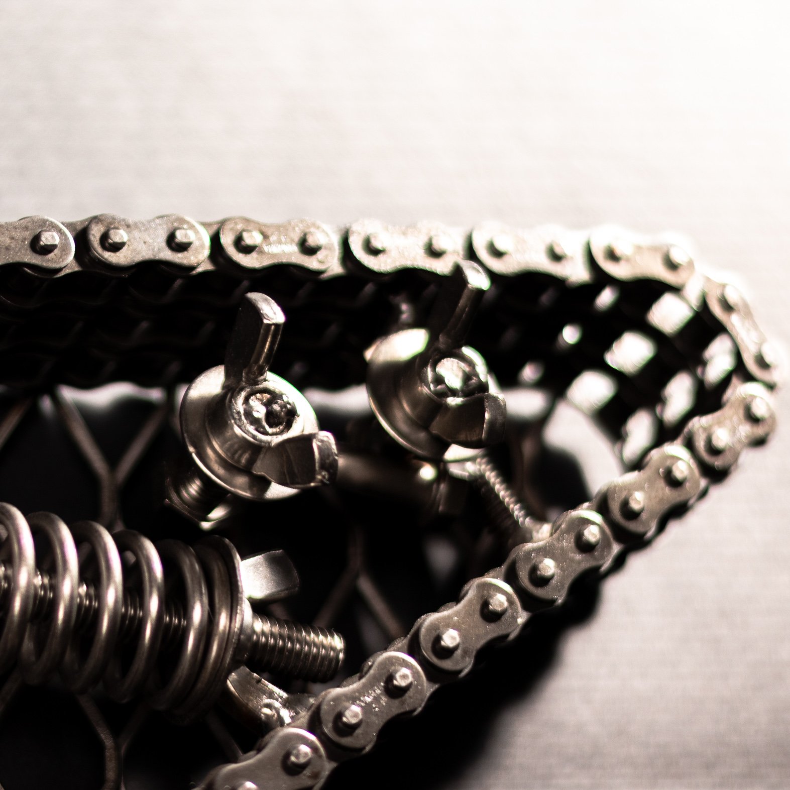 Handmade metal electric guitar sculpture, life-size, crafted from scrap metal with a clear finish.