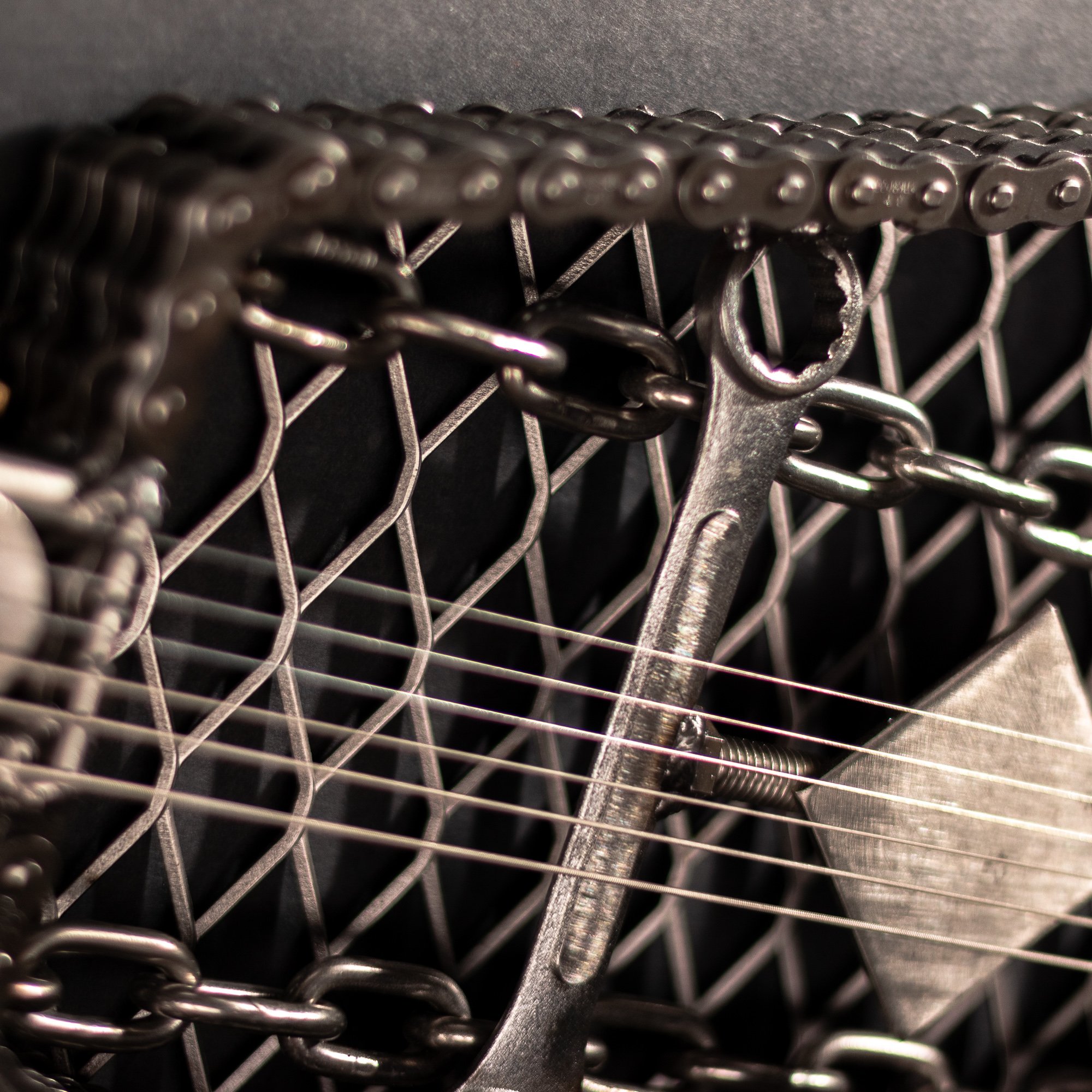 Handmade metal electric guitar sculpture, life-size, crafted from scrap metal with a clear finish.