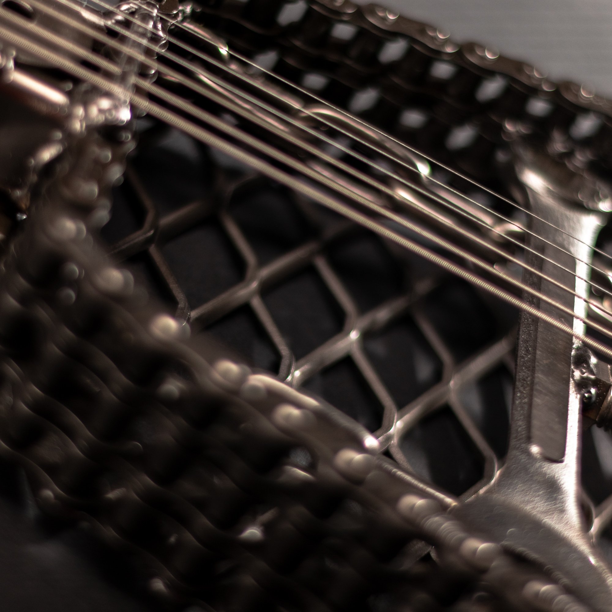 Handmade metal electric guitar sculpture, life-size, crafted from scrap metal with a clear finish.