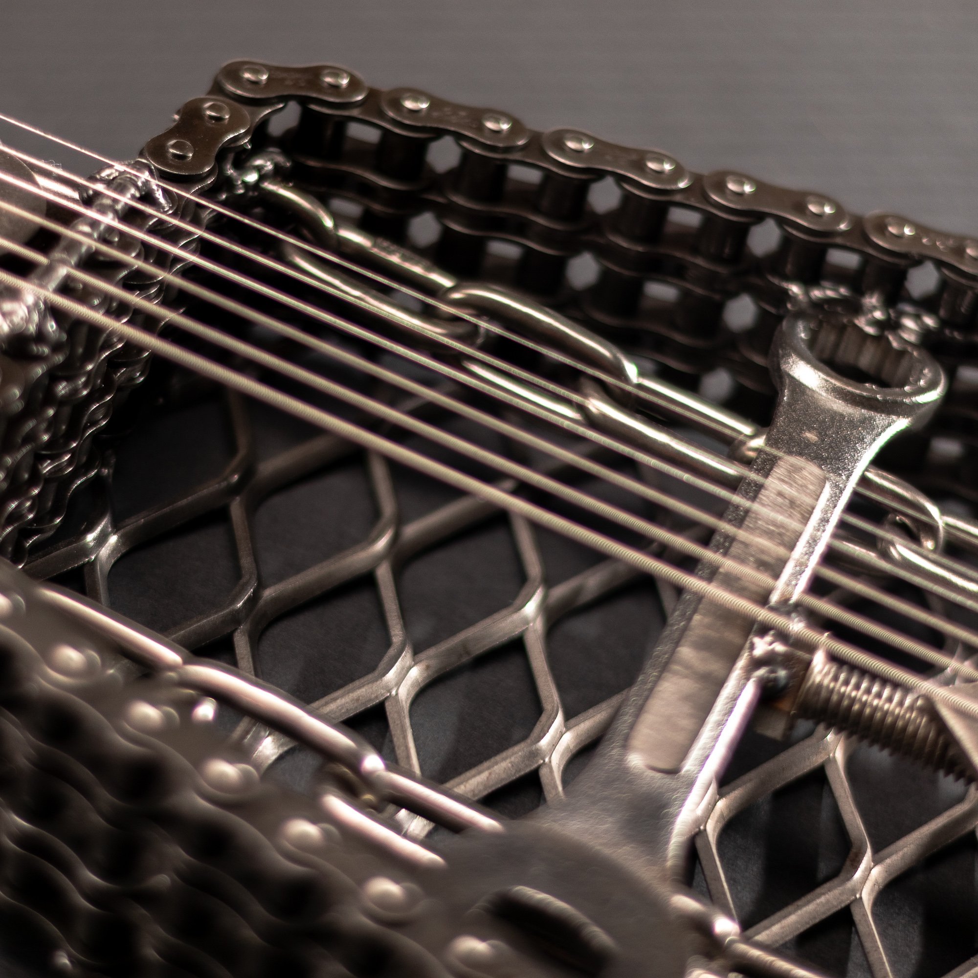 Handmade metal electric guitar sculpture, life-size, crafted from scrap metal with a clear finish.