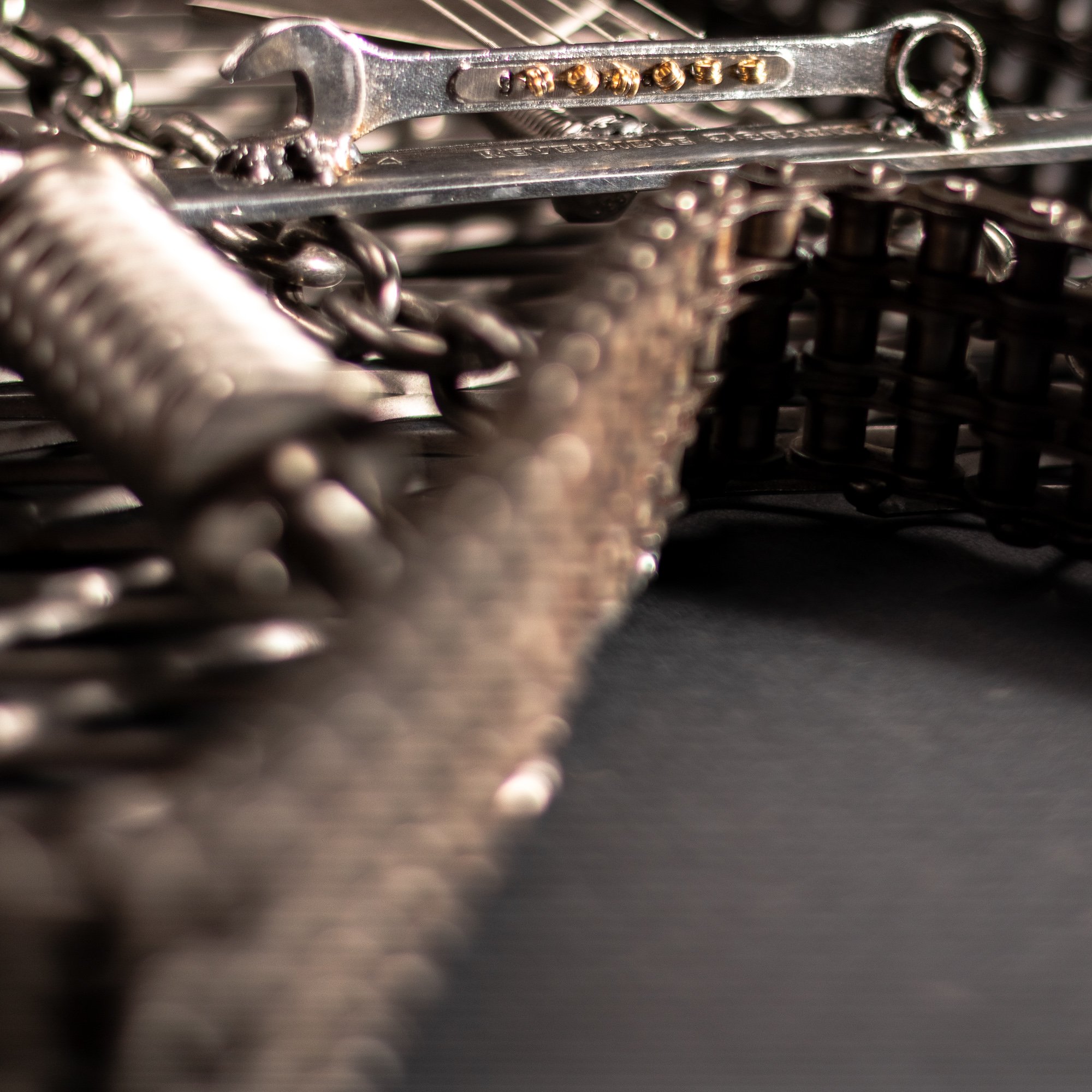 Handmade metal electric guitar sculpture, life-size, crafted from scrap metal with a clear finish.