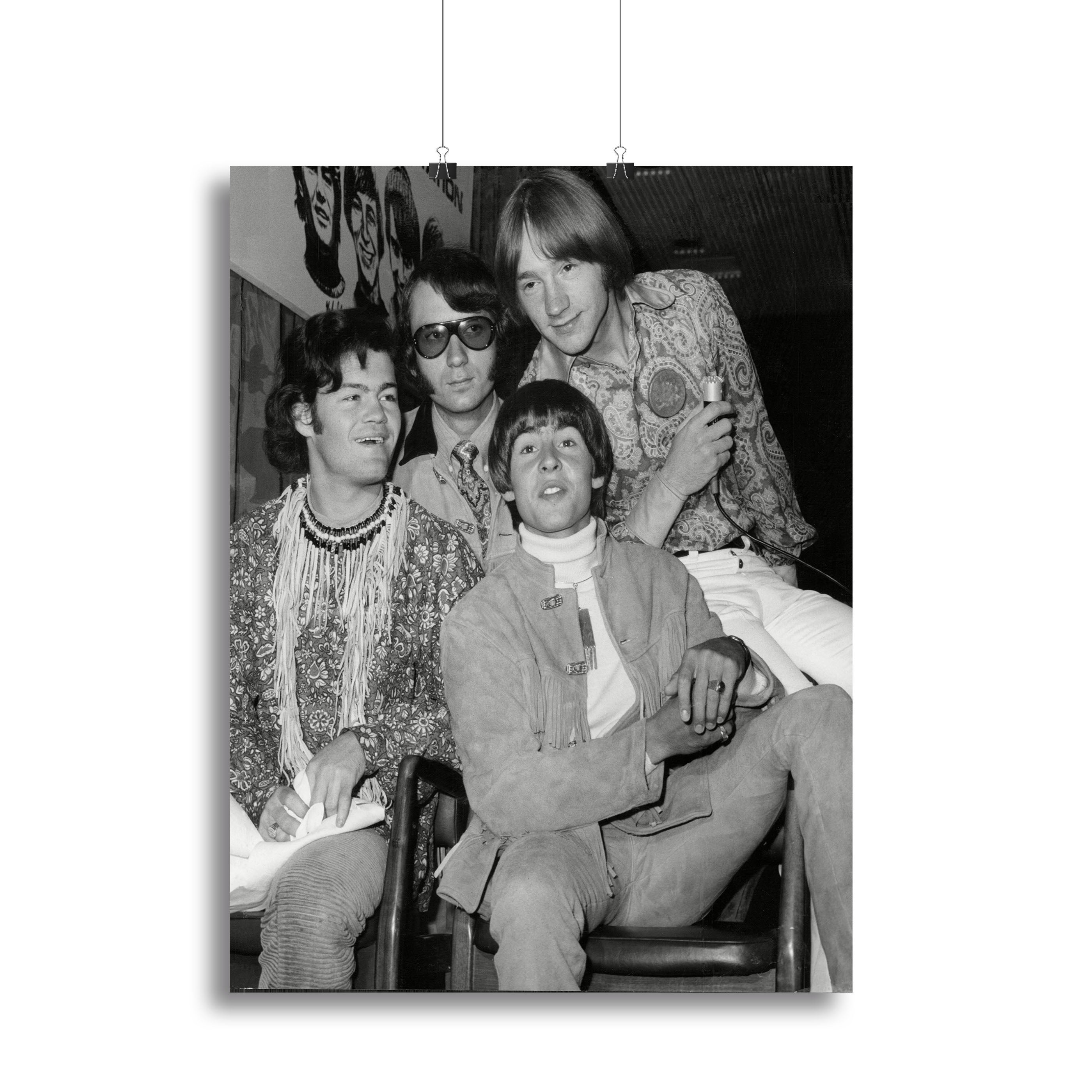 A vibrant canvas print featuring The Monkees sitting together, showcasing their iconic style and charm.