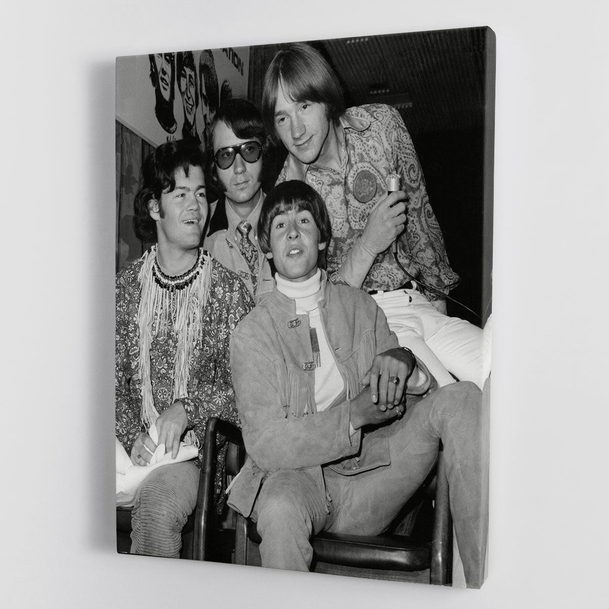 A vibrant canvas print featuring The Monkees sitting together, showcasing their iconic style and charm.