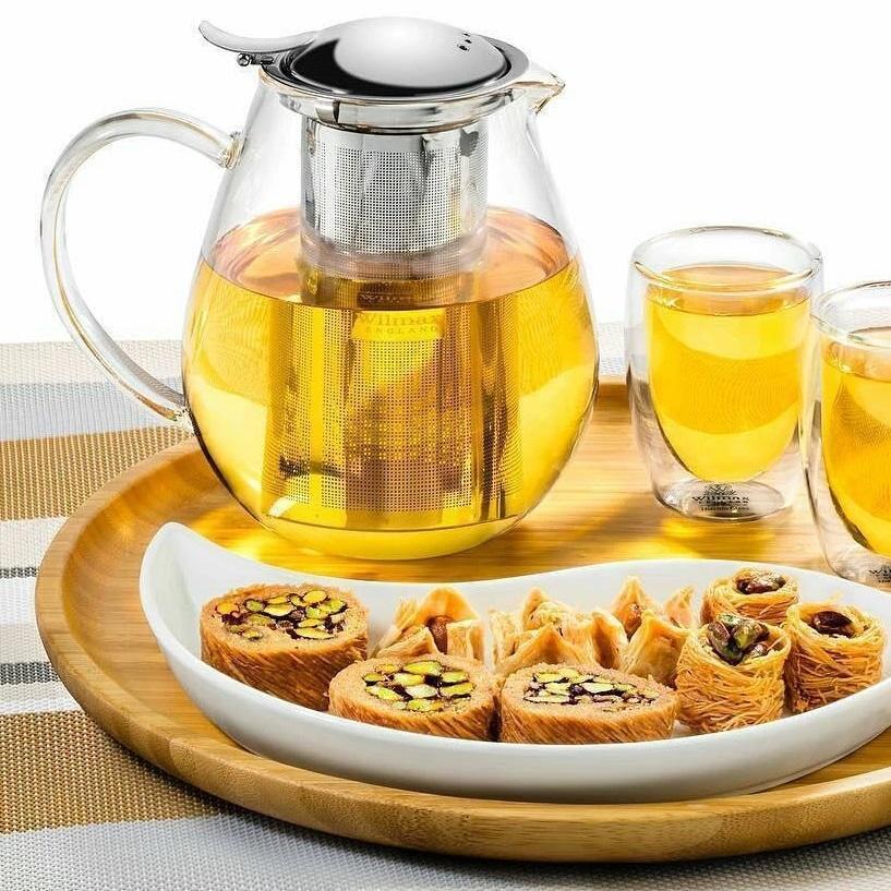 Elegant Thermo Glass Teapot made of borosilicate glass with a bamboo lid and stainless steel infuser, perfect for hot and cold beverages.